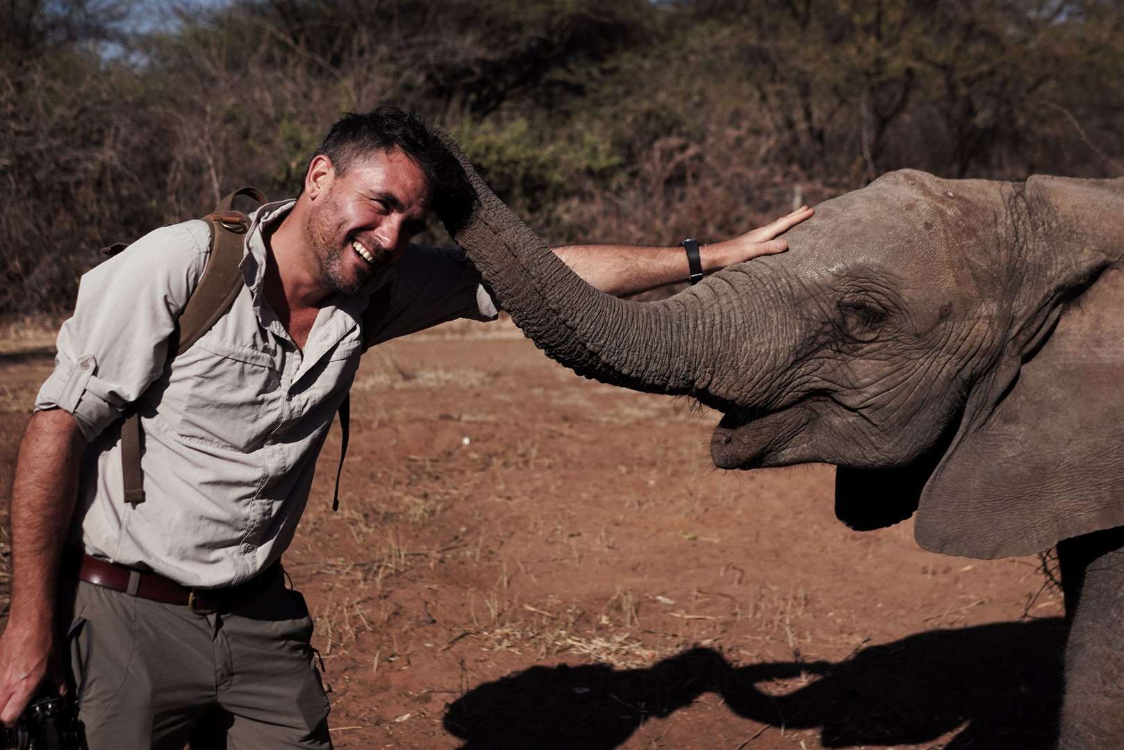 Levison Wood with an orphaned elephant in Botswana. Picture: PA Photo/Simon Buxton