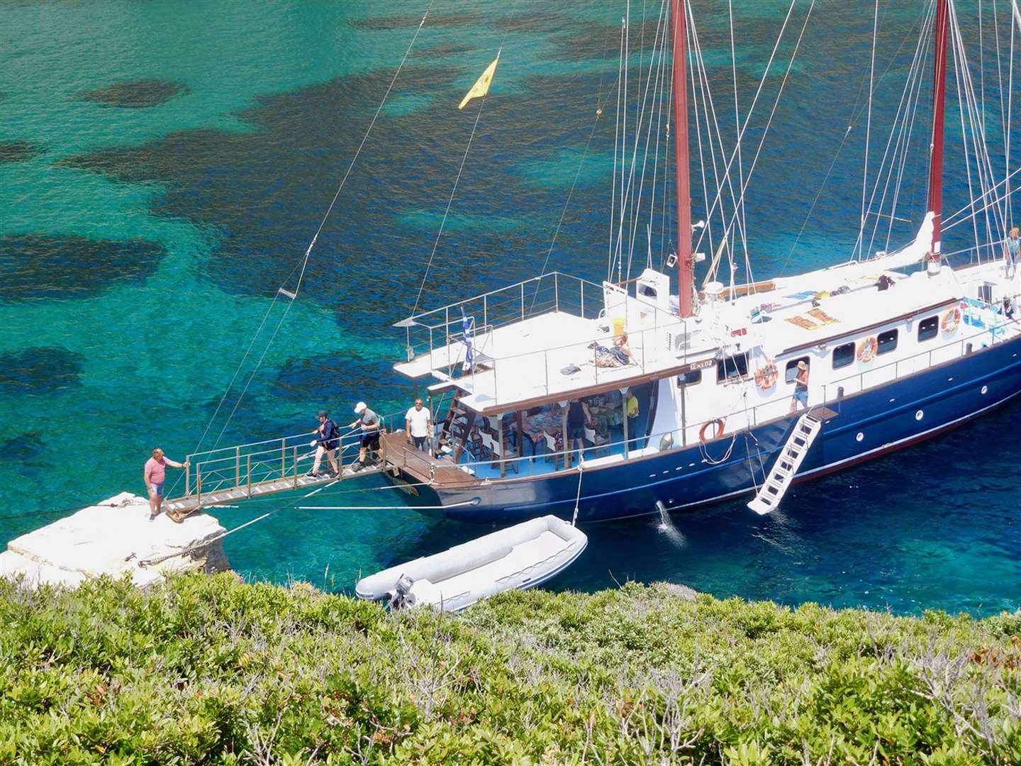Guests disembarking a sailing boat at Kyra Panagia island. Picture: PA Photo/Fiona Webster