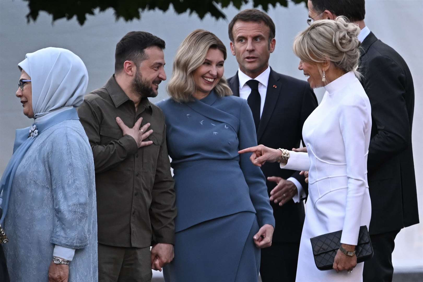 Ukrainian president Volodymyr Zelensky and his wife Olena Zelenska talk with French President Emmanuel Macron and his wife Brigitte Macron as they arrive for the social dinner during the Nato summit in Vilnius (Paul Ellis/PA)
