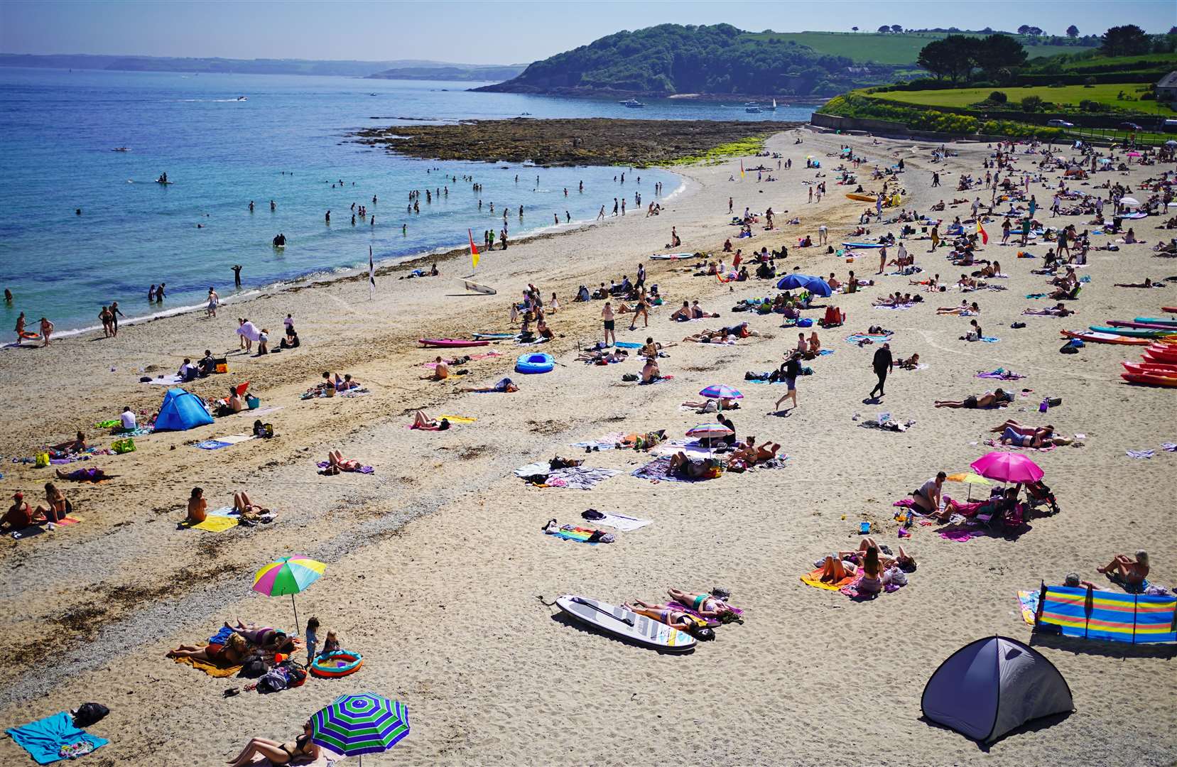 People enjoy the sunshine on Gyllyngvase Beach near Falmouth in Cornwall (Aaron Chown/PA)