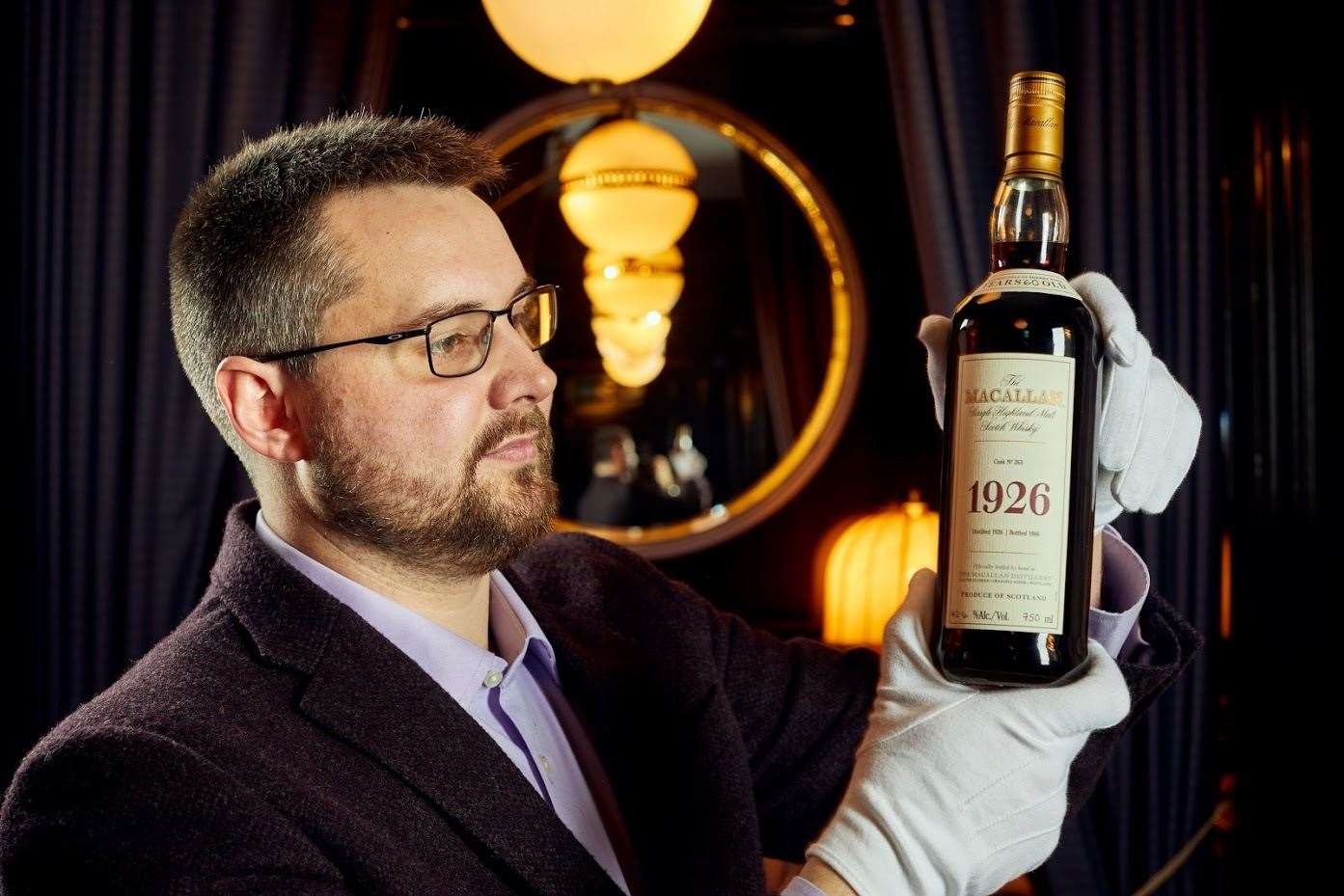 Whisky Auctioneer founder Iain Mcclune with the Macallan 1926.