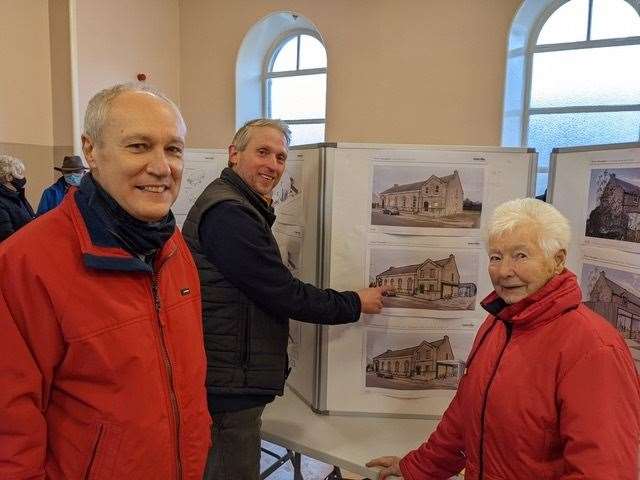 Bob Ferenth, Neil Mapes and Helen Petrie view some of the plans for the Seaman’s Hall at the open event.