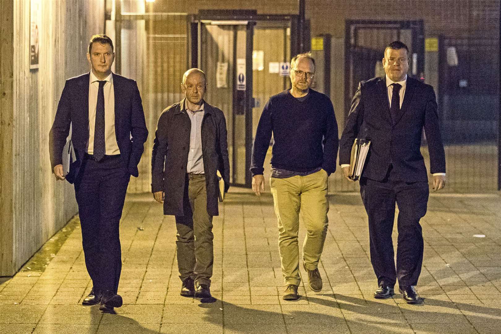 (Left to right) Solicitor John Finucane with his client, investigative journalists Barry McCaffrey, and Trevor Birney with his solicitor Niall Murphy leave a police station in Belfast after the reporters were arrested in 2018 (Liam McBurney/PA)