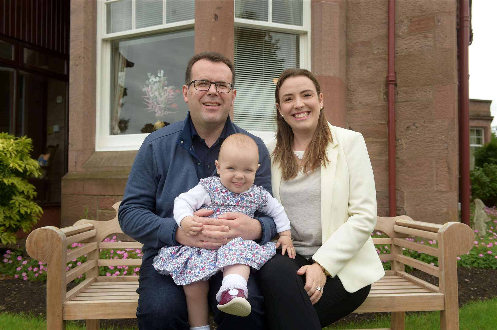 David and Roberta Shayer with baby Sophia outside their Inverness guest house.