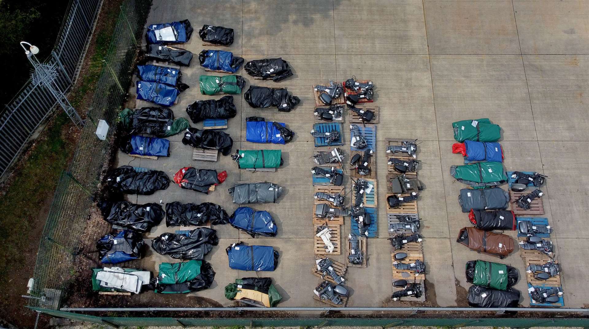 A view of small boats and engines used to cross the Channel by people thought to be migrants at a warehouse facility in Dover (PA)