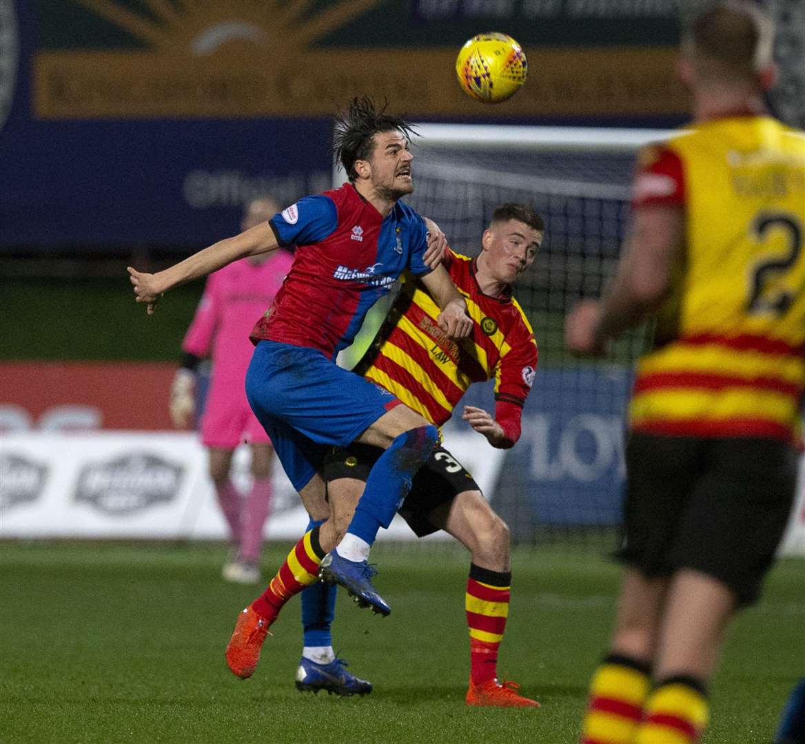 ICT's Charlie Trafford knocks the ball away from Partick's Lewis Mansell.