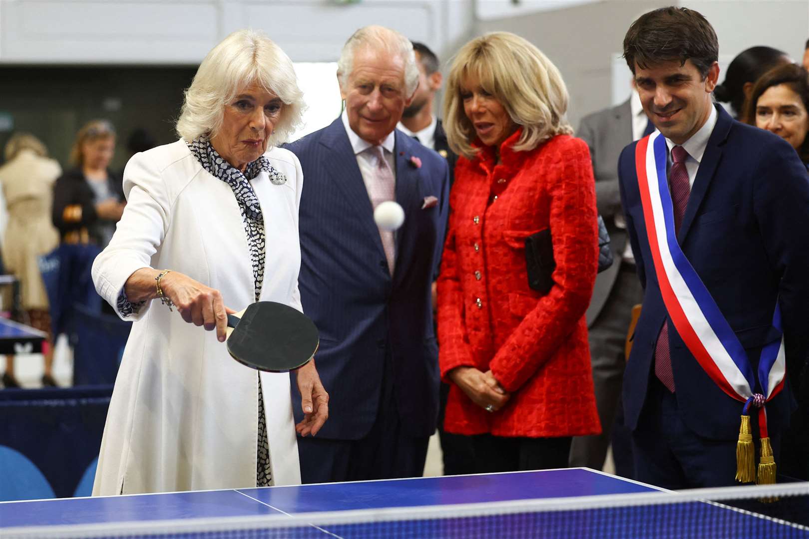 The Queen played table tennis next to the King and Brigitte Macron, during a visit to a local youth sports association in Saint-Denis (Hannah McKay/PA)