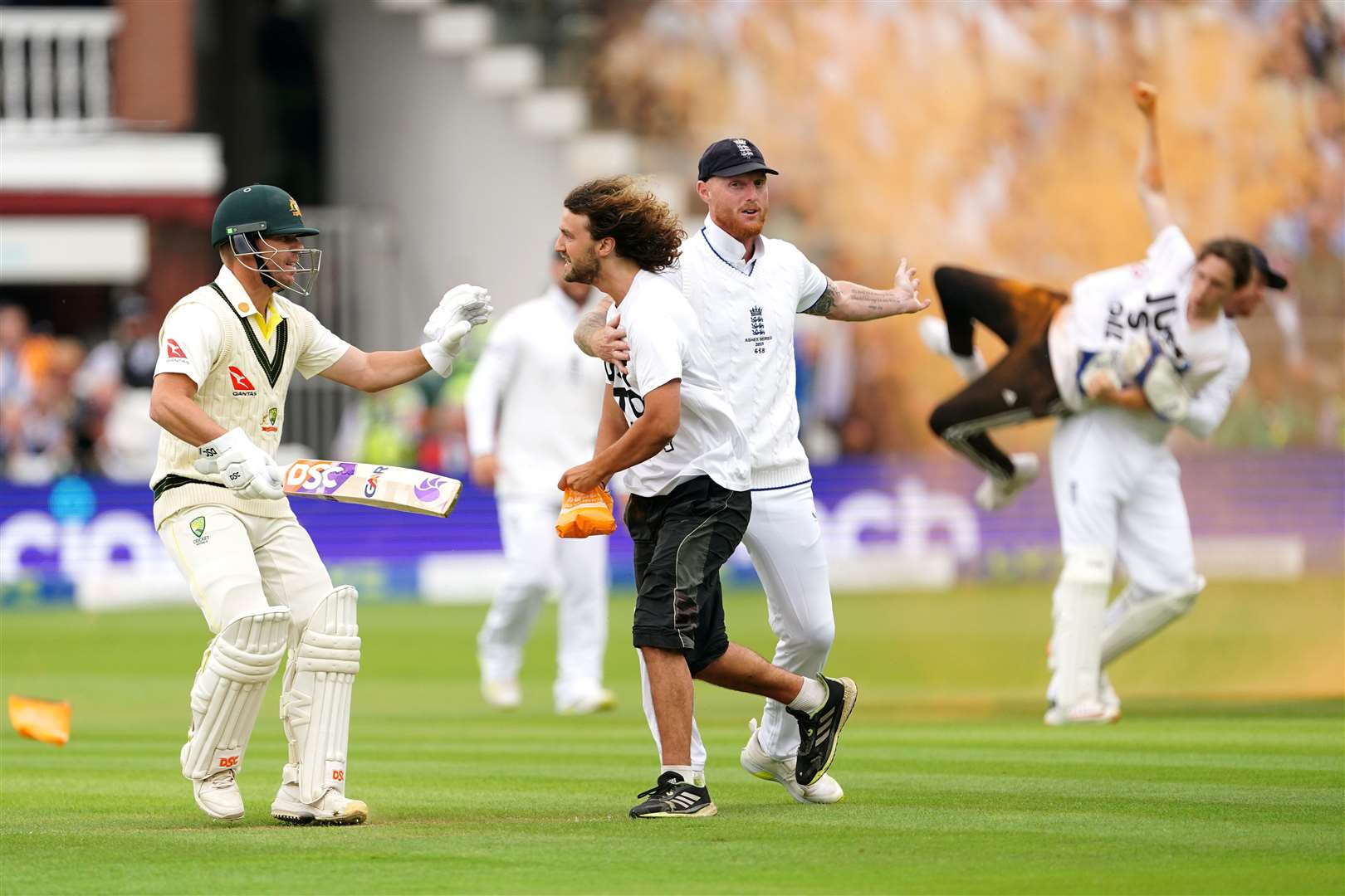 England cricketers grab Just Stop Oil protesters during day one of the second Ashes test match at Lord’s, London on June 28 (Mike Egerton/PA)