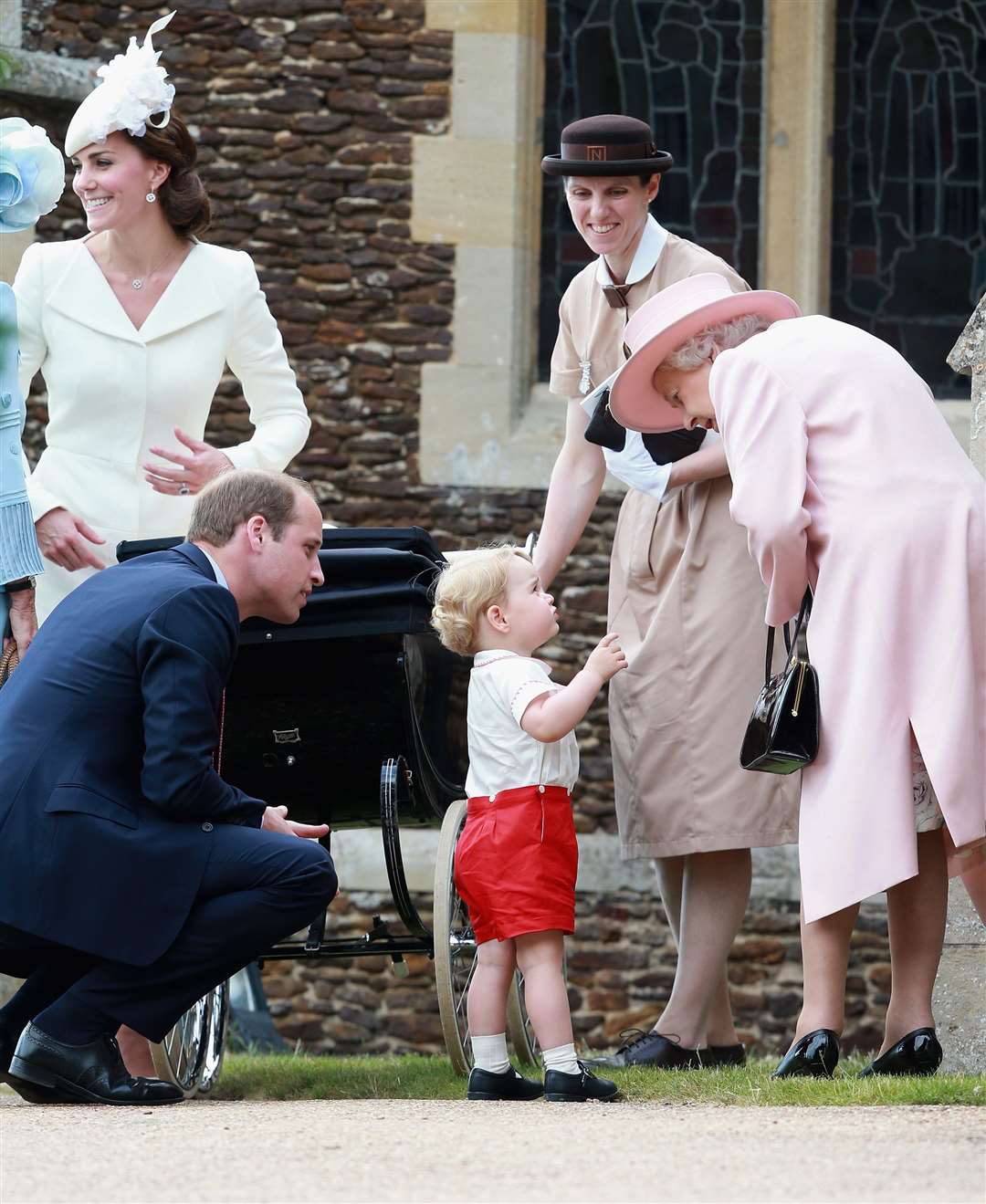 In 2015, future king Prince George speaks with his great-grandmother, the Queen, at Princess Charlotte’s christening (Chris Jackson/PA)