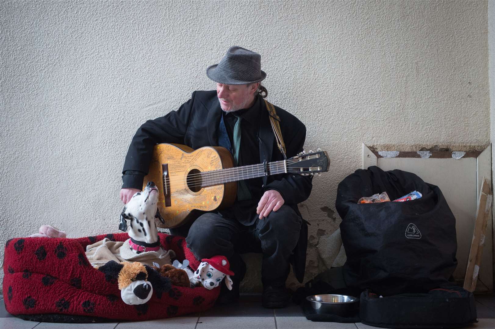 Busker John Casey and Emily the Dalmatian in the city centre's Victorian Market.