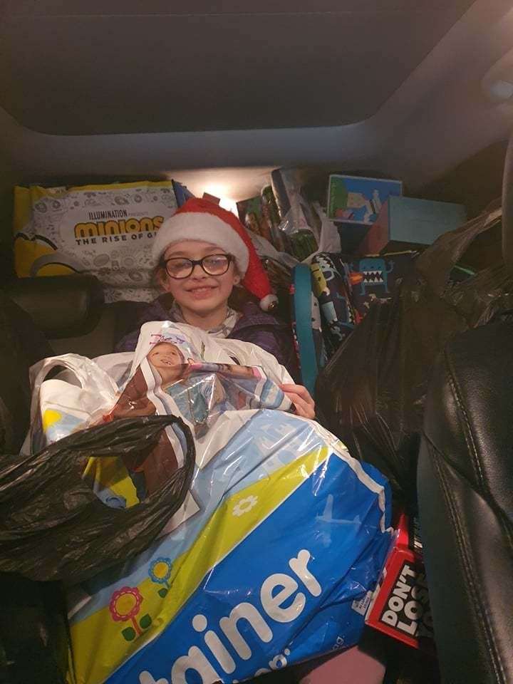 Savannah Kelly surrounded by gifts for the hospital.