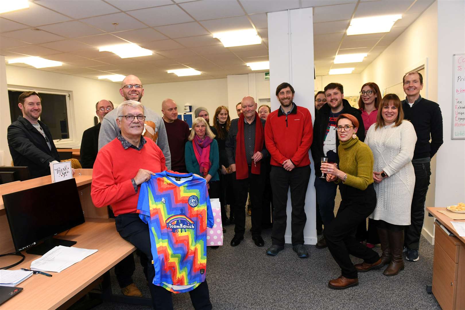 Donald with one of his leaving gifts and his colleagues on the day of his retirement. Picture: Callum Mackay.