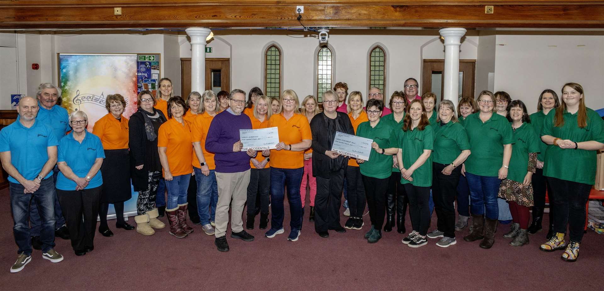 The Accidentals presenting the cheque to Simon Noble (Wheels in Nairnshire) and Julie McIntosh (Hydrotherapy Pool). Picture: Mark Giles, Nairn Camera Club.