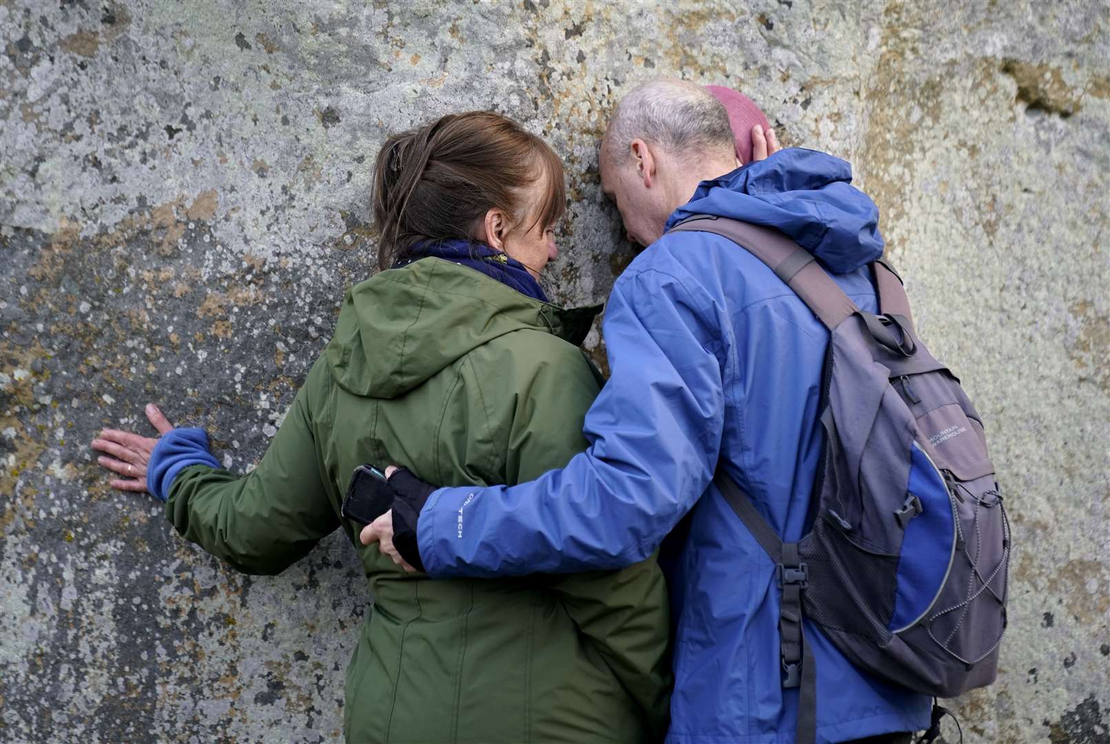 People touch one of the stones at the monument (Andrew Matthews/PA)