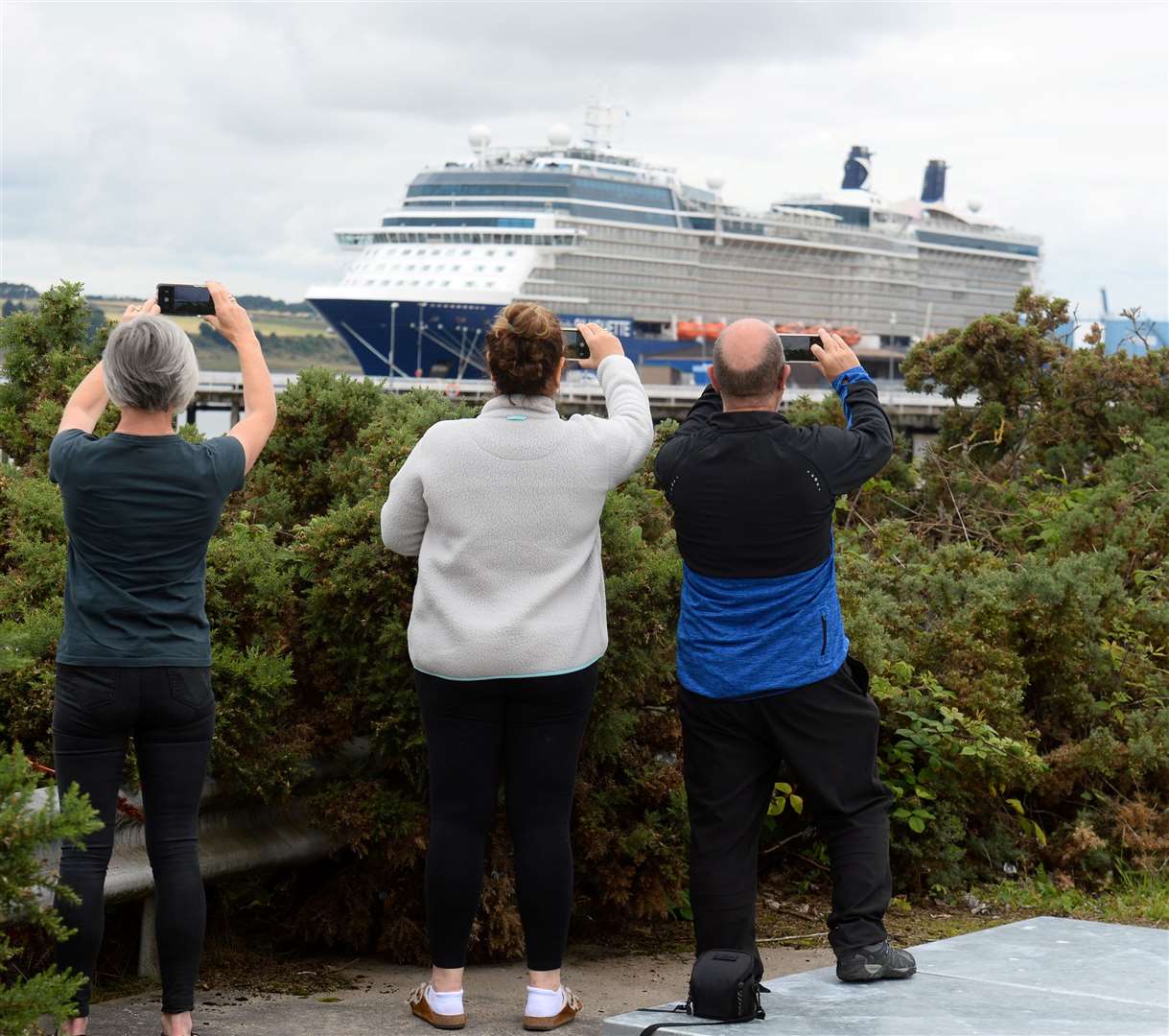 Locals capture photos of the huge vessel. Picture: Gary Anthony