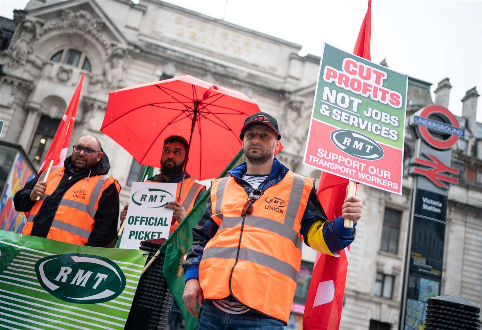 Members of the RMT union on a picket line outside Victoria station in London (Dominic Lipinski/PA)