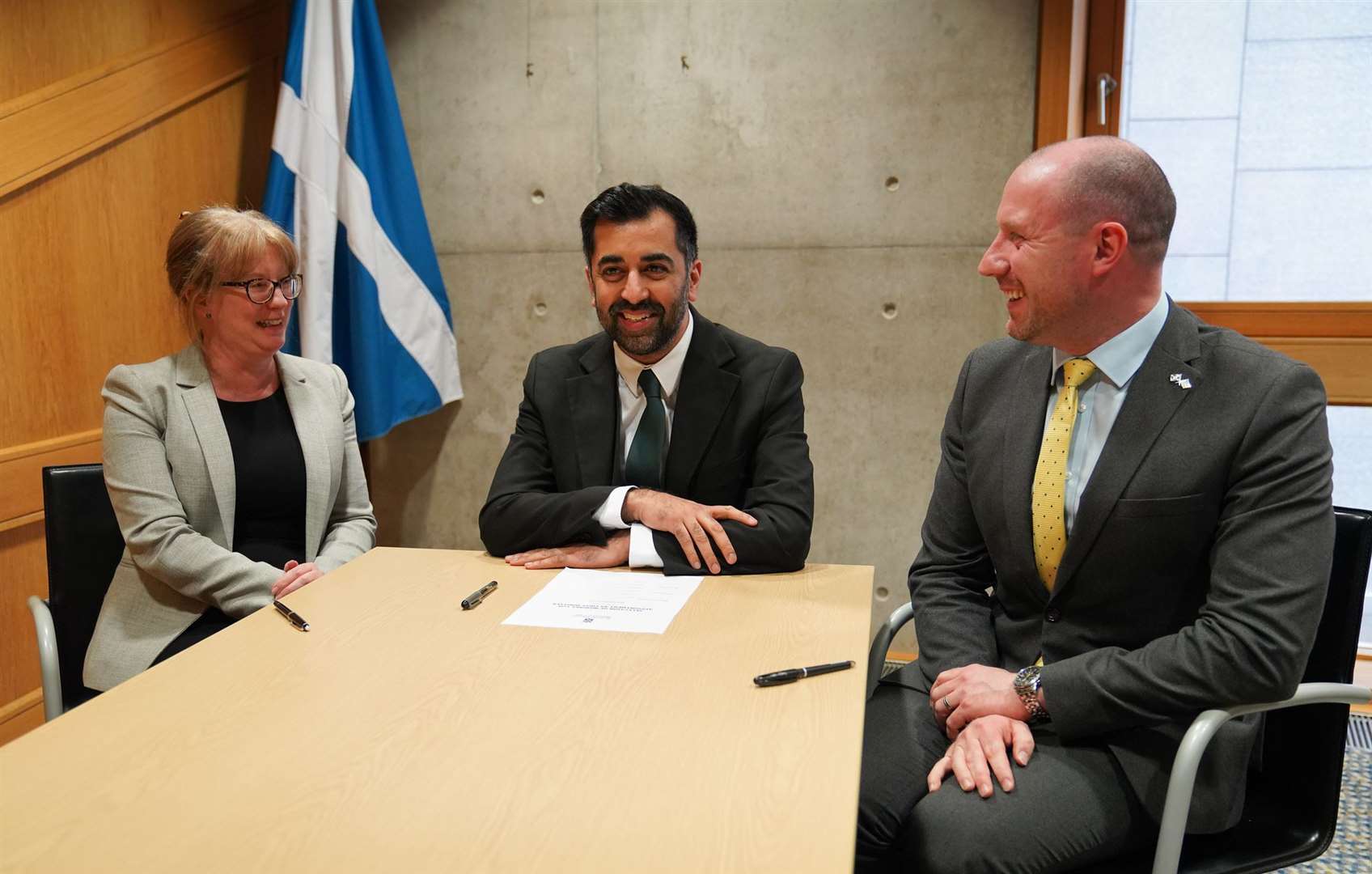Humza Yousaf signs his nomination paper to become First Minister, nominated by Shona Robison and Neil Gray.