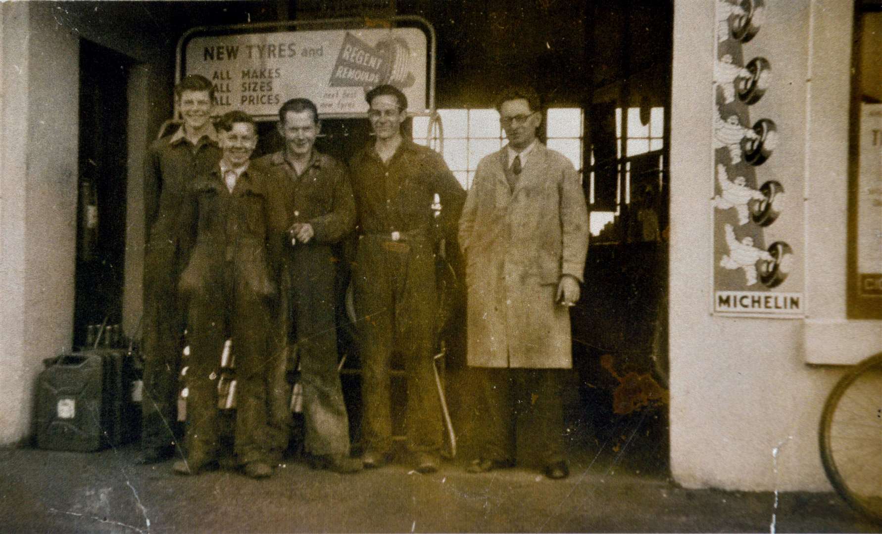 Norman Malcolm, extreme right, the previous garge owner with some members of staff including Willie McBean, Sinclair Sutherland, and William Milne.