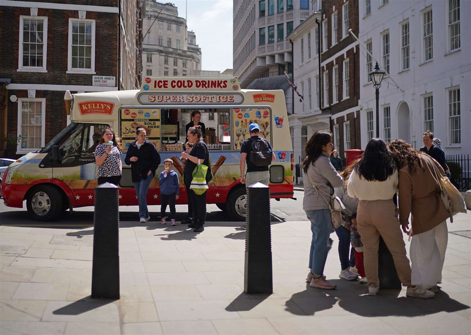 People buying ice cream from an ice cream van near St James’s Park, London, during the warm weather (Yui Mok/PA)