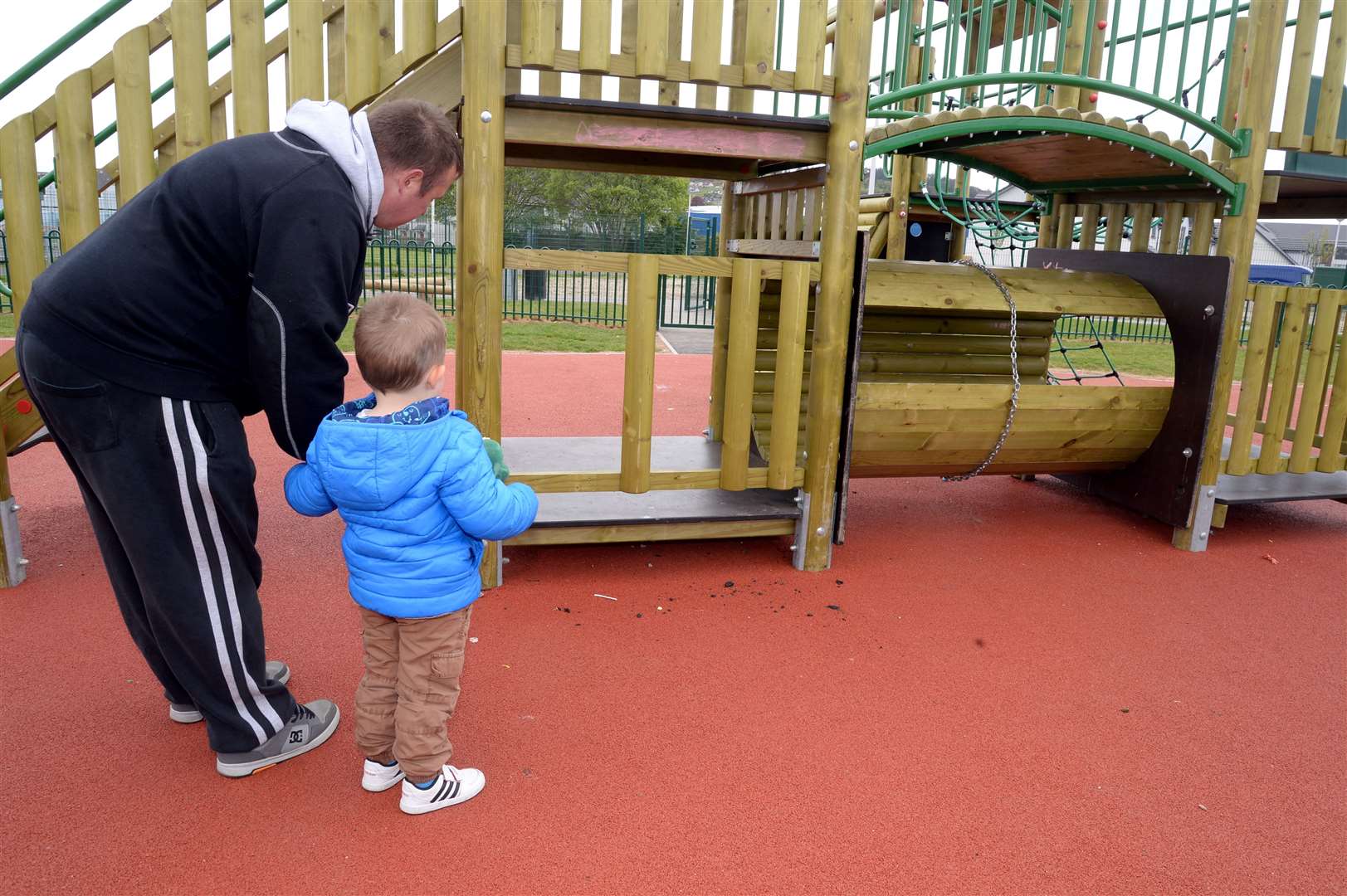 Michael Catterson with his son looking at the damaged park.