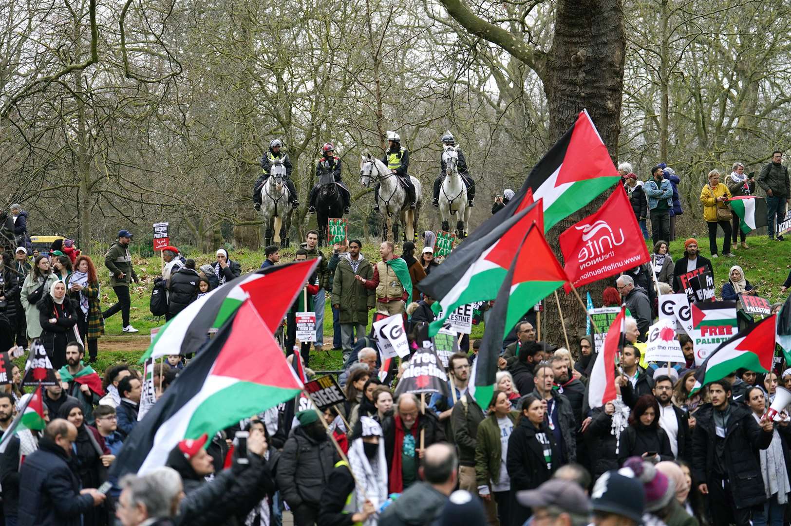 Mounted police officers watch as people take part in a pro-Palestine march (Jordan Pettitt/PA)