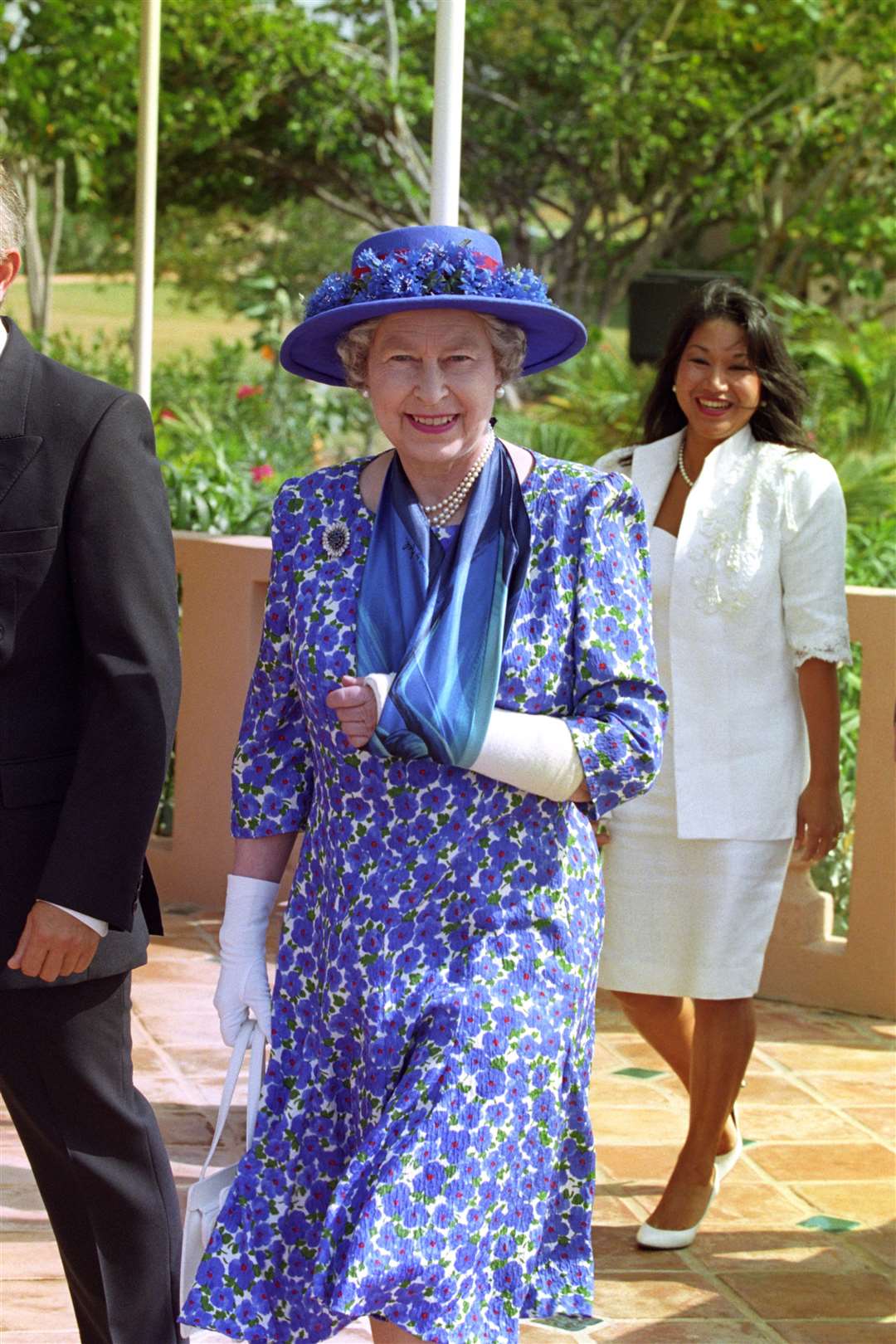 The Queen wears her plaster cast arm in a sling while visiting Anguilla (Martin Keene/PA)