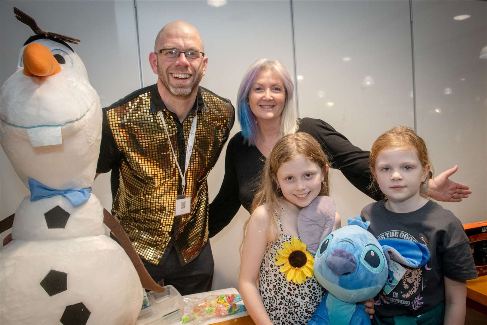 Andy Dixon and Ruth Mason along with helpers Iona and Emily at our quiz night (plus the huge Olaf and Stitch prizes).