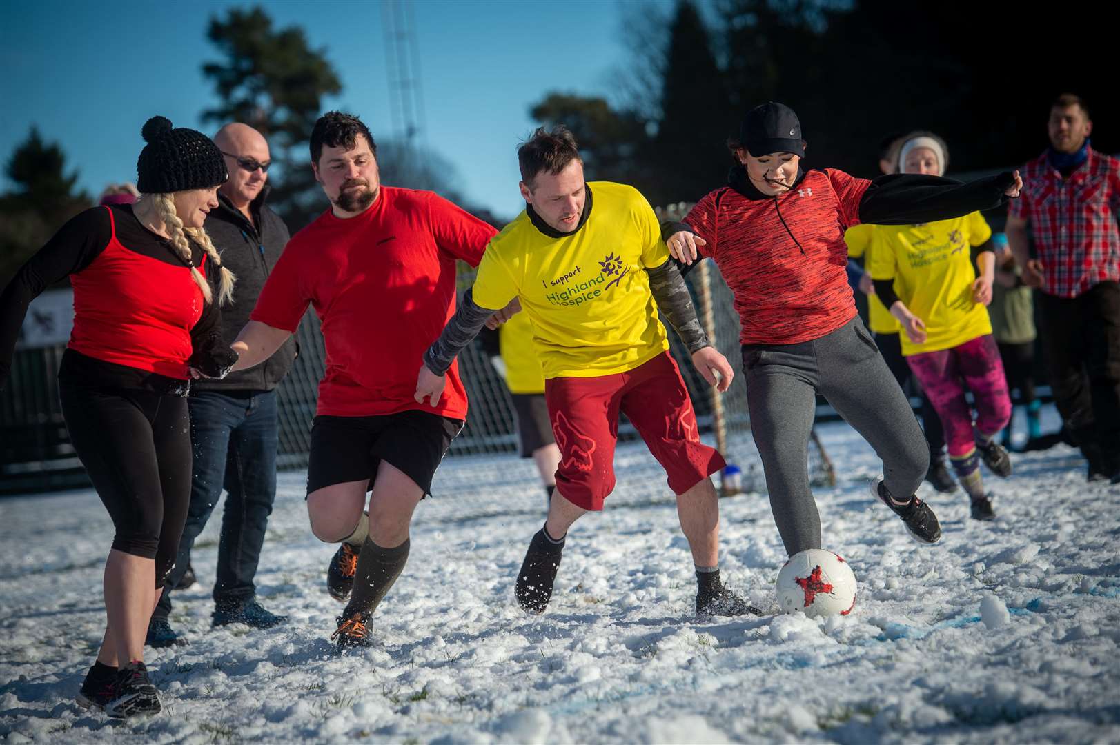 The teams battled it out on the snowy pitch.