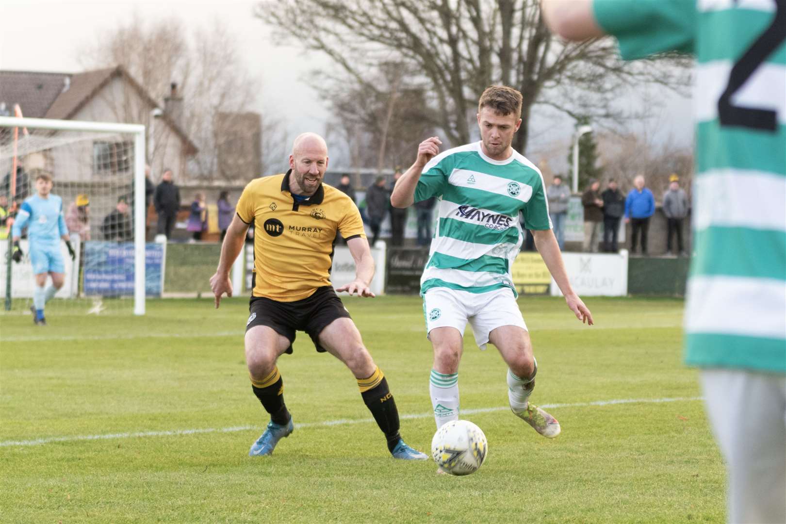 Nairn's Ross Tokely and Buckie Thistle's Scott Adams keep their eyes on the ball. ..Picture: Beth Taylor.