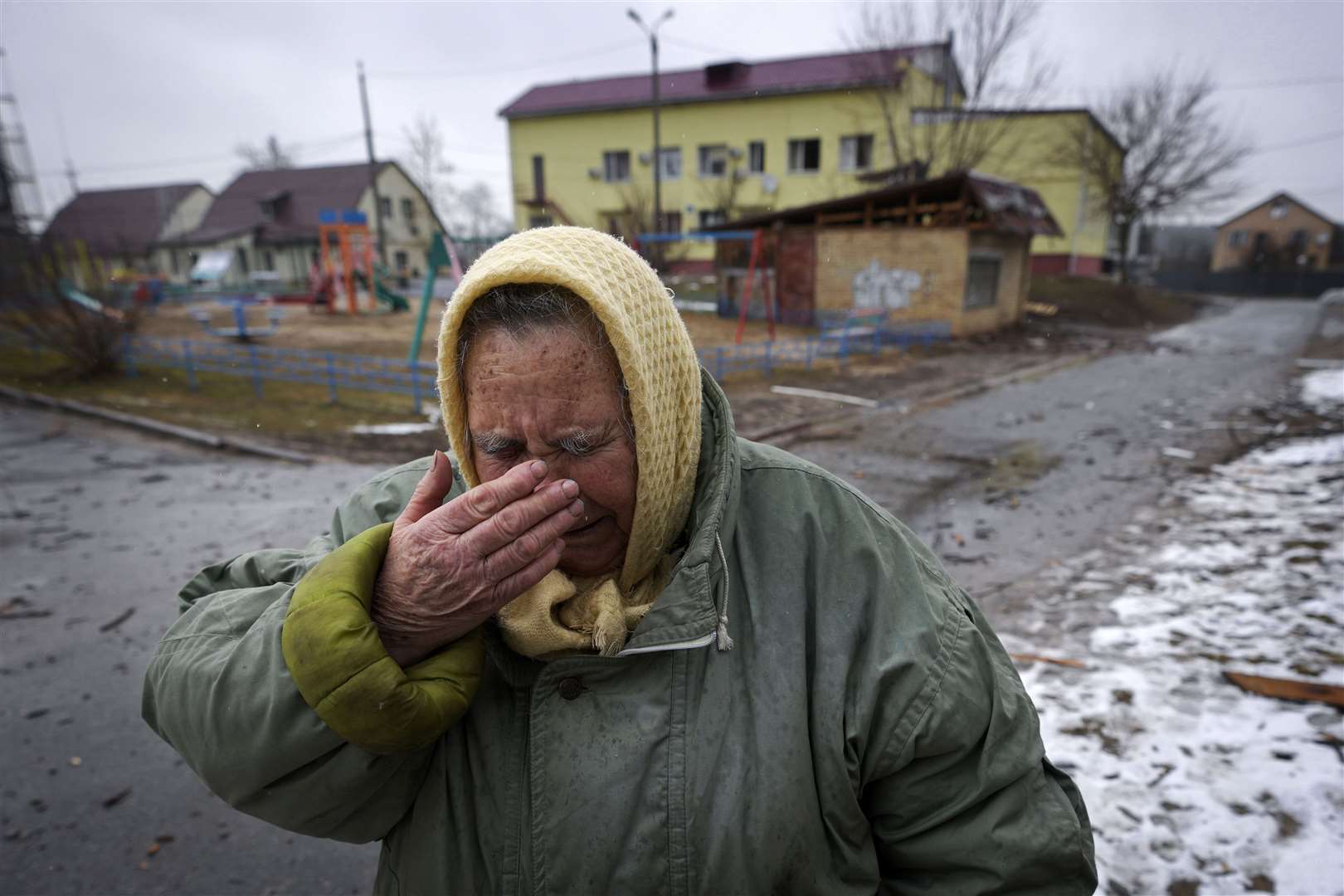 A woman cries outside houses damaged by a Russian air strike near the Ukrainian capital Kyiv (Vadim Ghirda/AP)