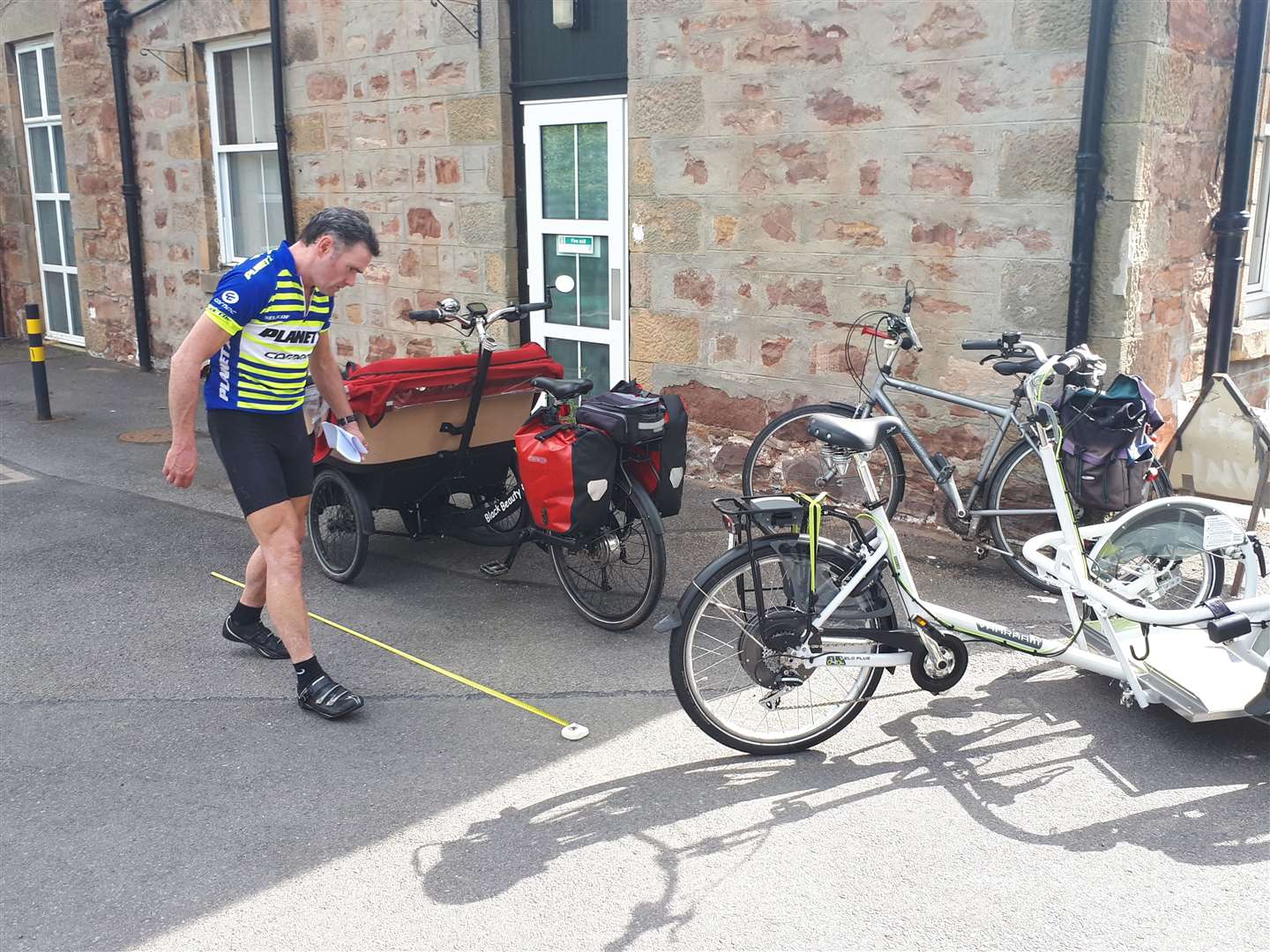 Graeme Campbell of Highland Council checking the dimensions of the trikes.
