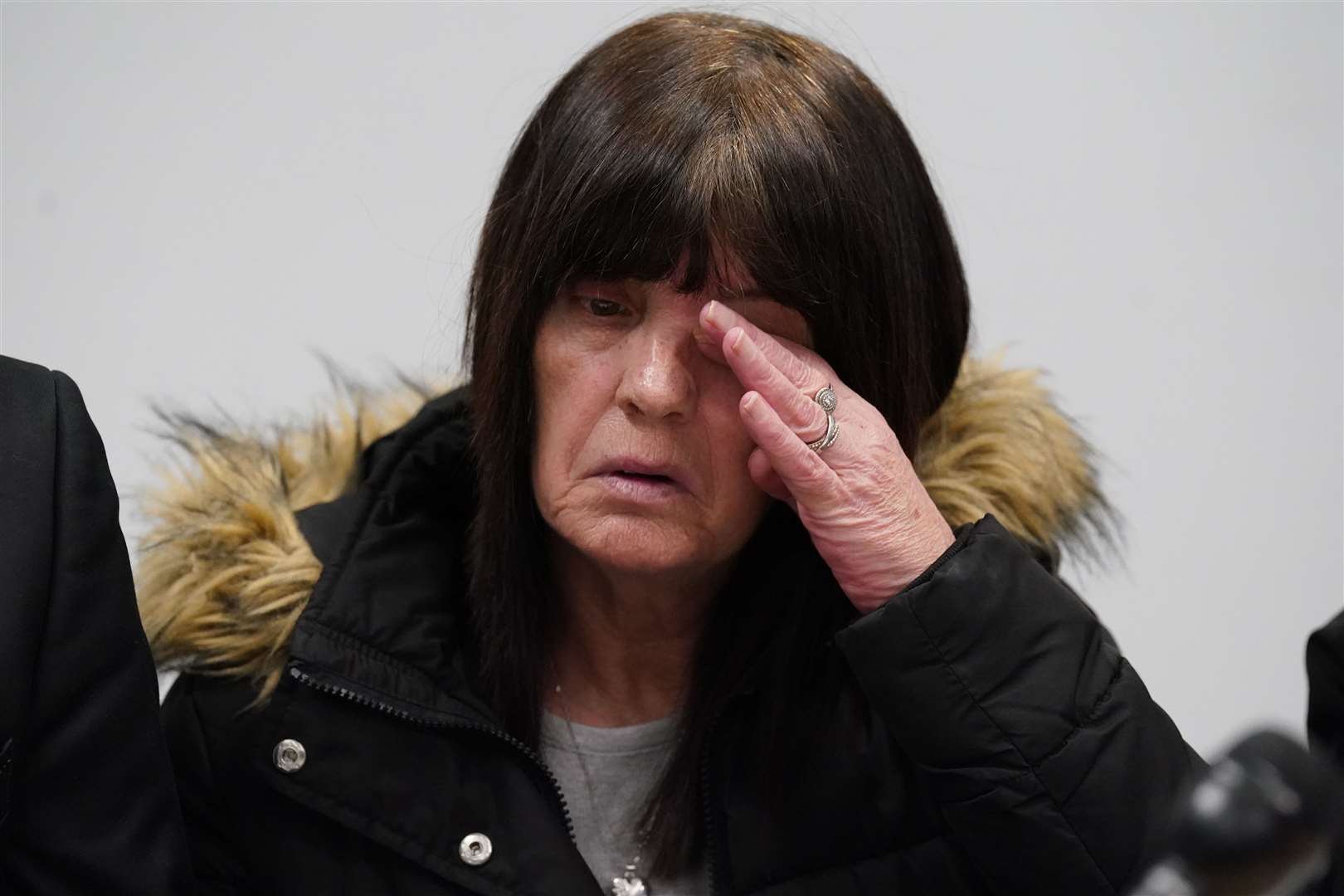 Jane Sneddon, the mother of Joseph Sneddon, wipes her eye during the press conference (Andrew Milligan/PA)