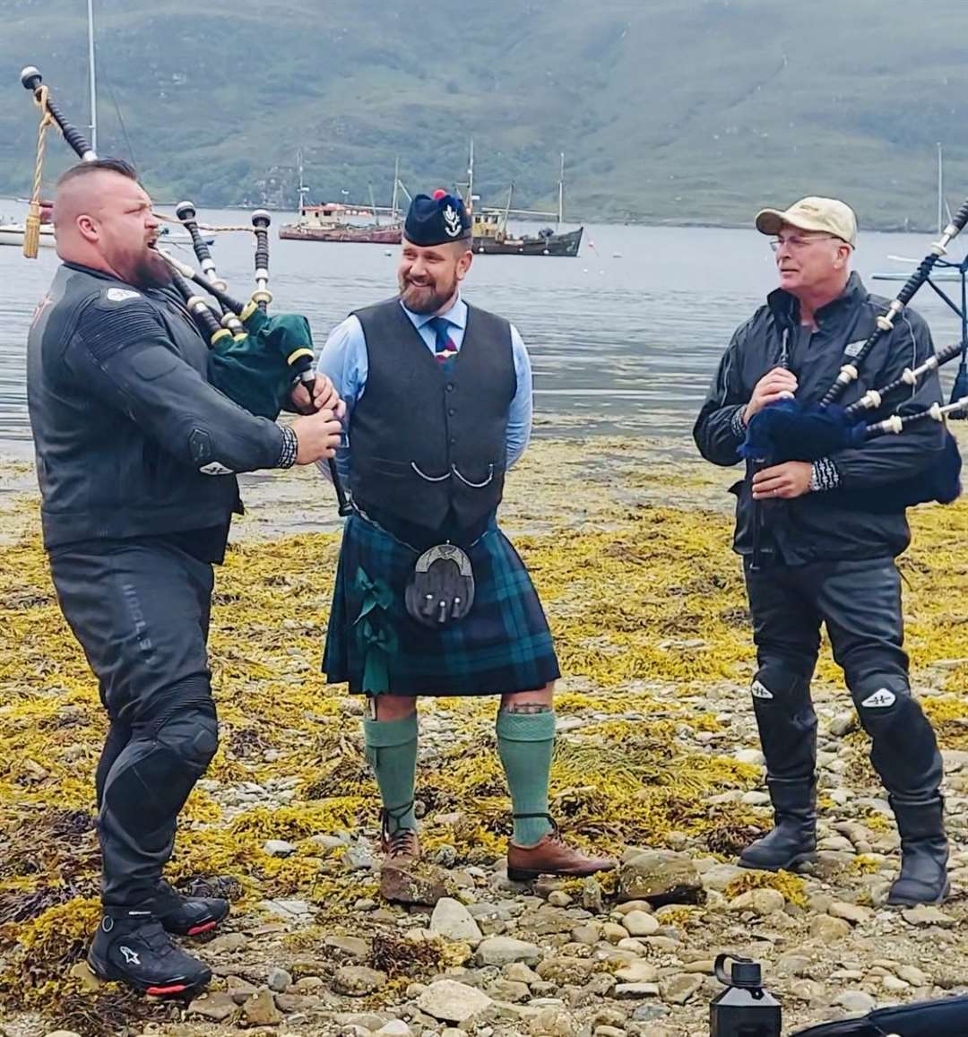 Bagpiper Jason Faulkner with Eddie Hall and his dad.