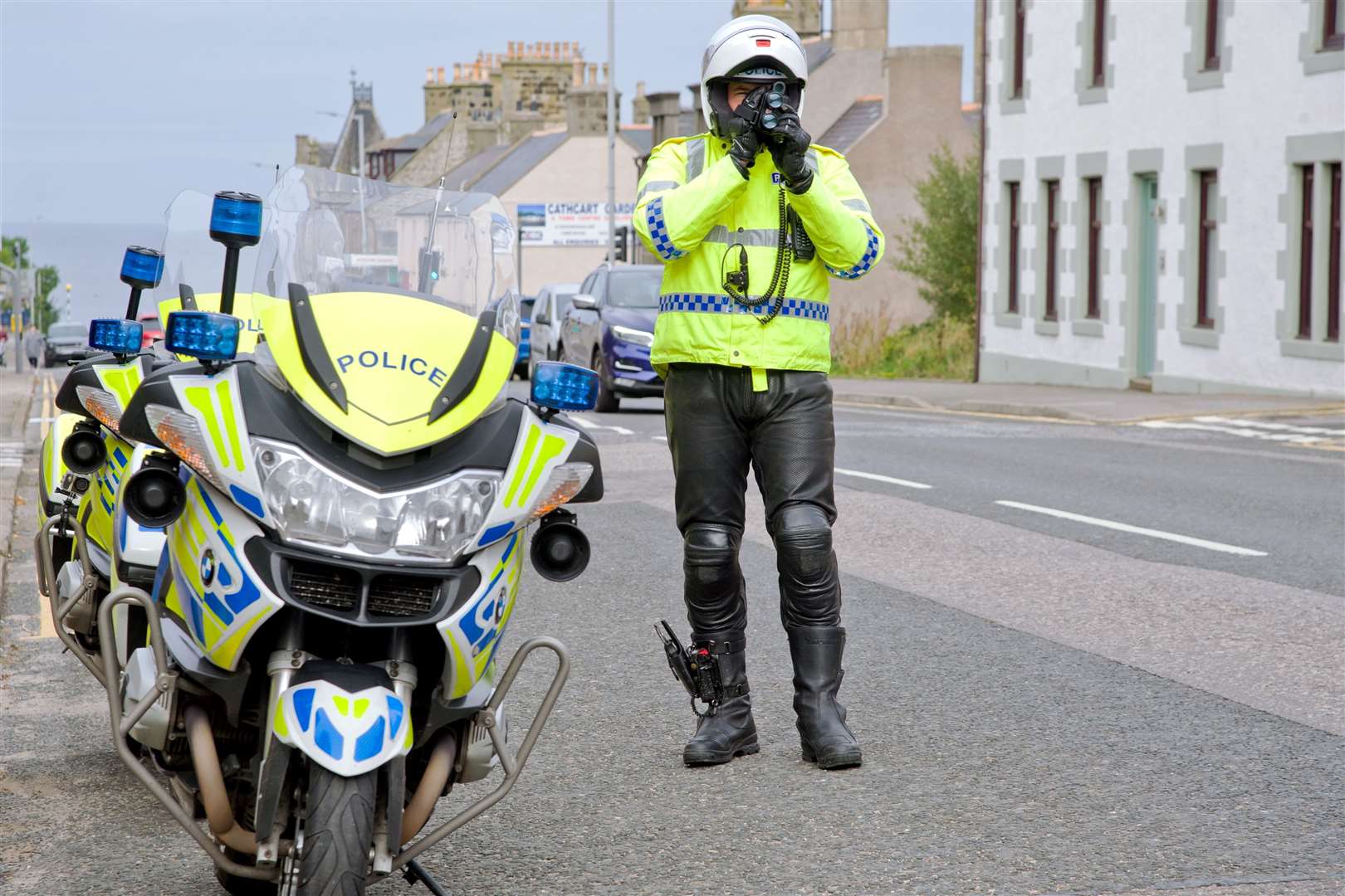 A police motorcyclist carries out a roadside check.