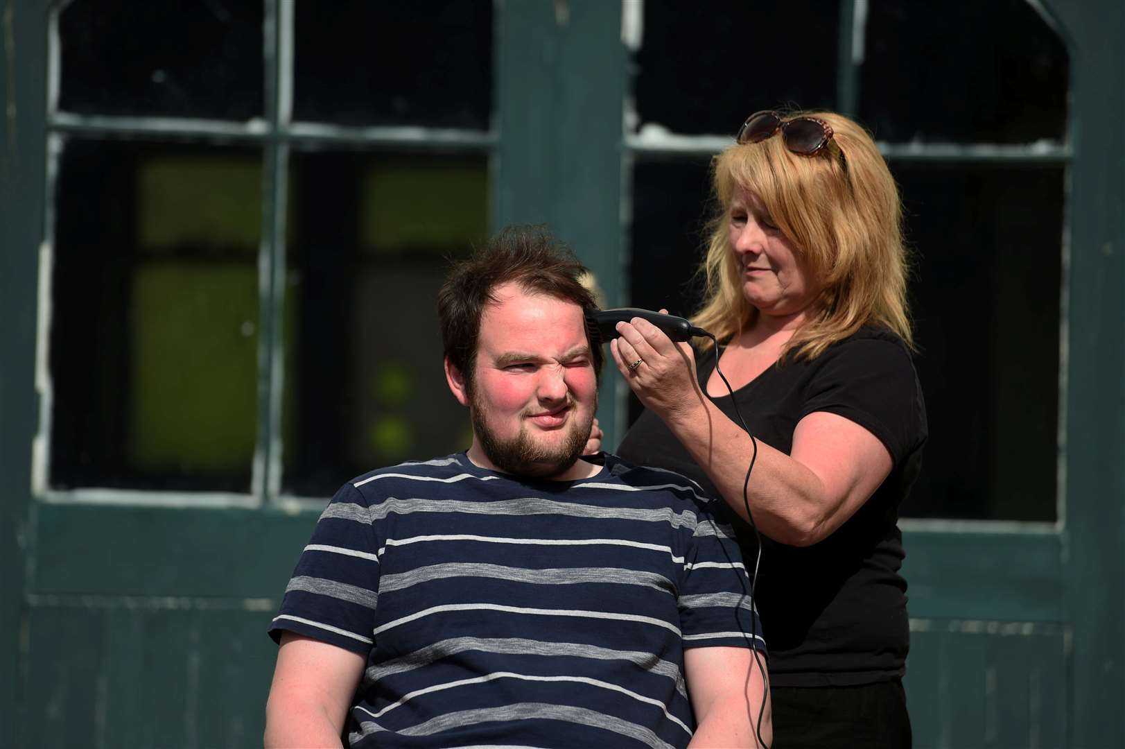 Miriam Veals cuts James O'Donnell's hair. Picture: Callum Mackay