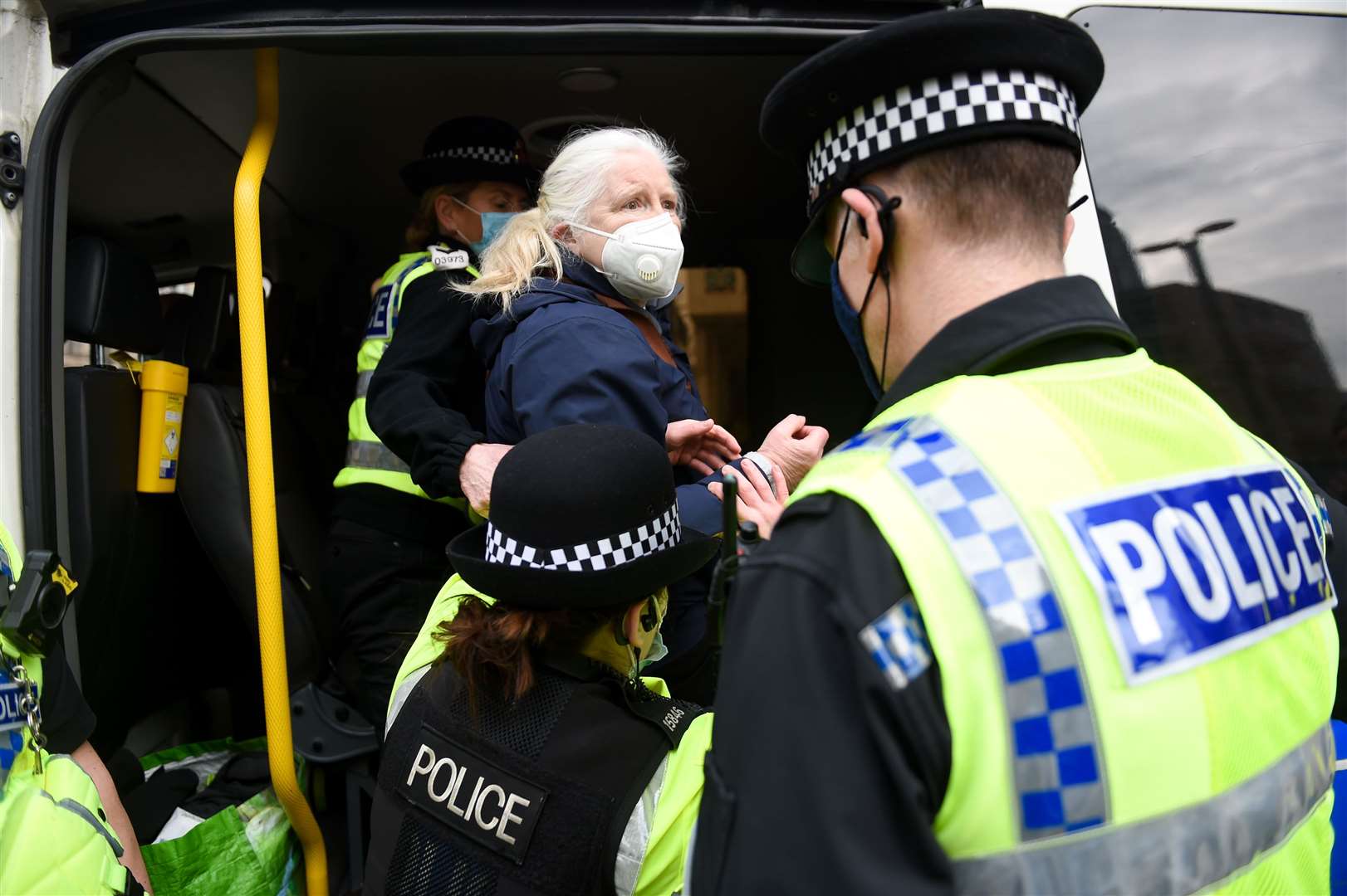 Police detain a demonstrator after breaking up a protest in Manchester, over the proposed 1% pay rise for NHS workers (Jacob King/PA)