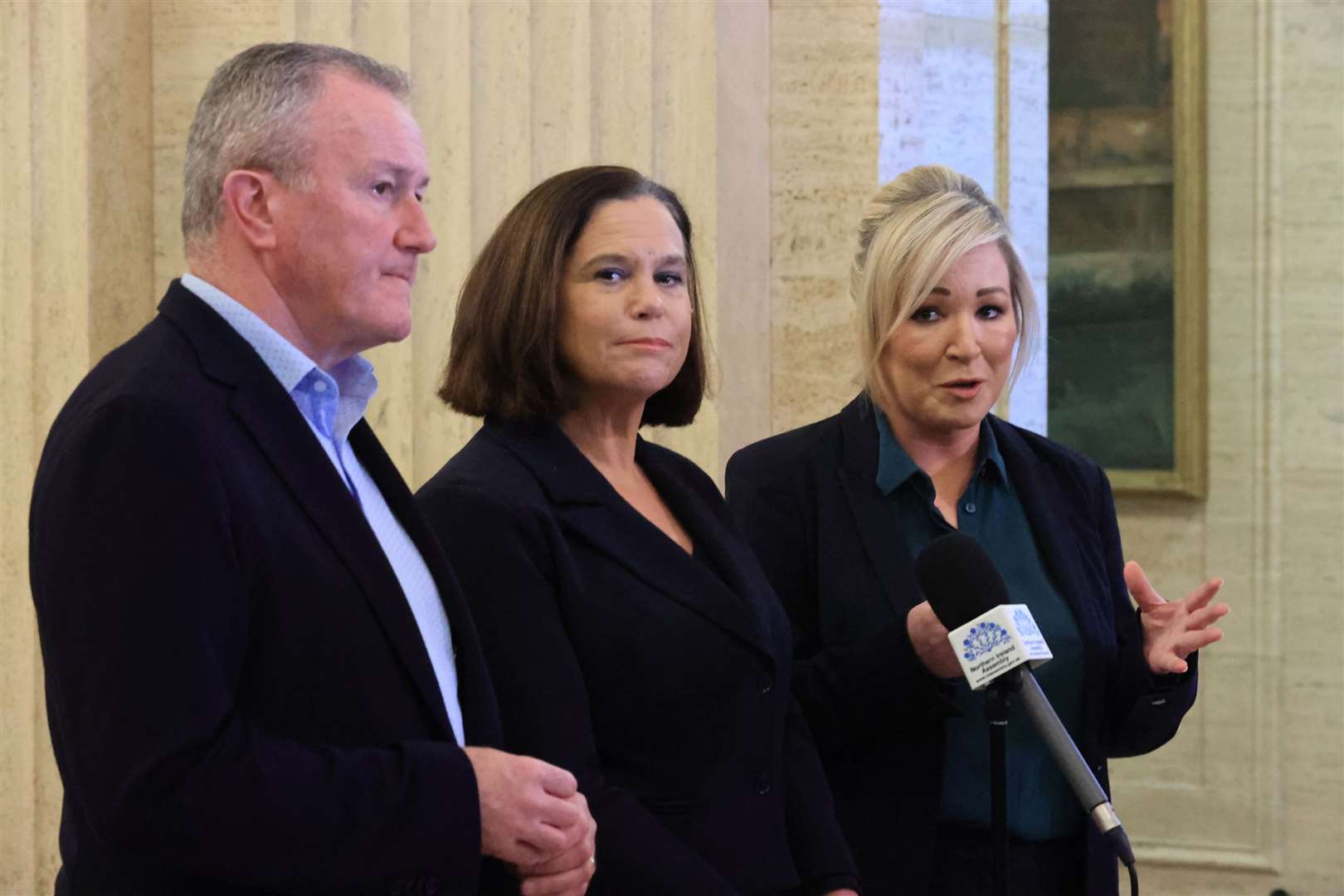 (left to right) Sinn Fein representatives MLA Conor Murphy, president Mary Lou McDonald and vice-president Michelle O’Neill, speak to the media in the Great Hall at Stormont (Liam McBurney/PA)