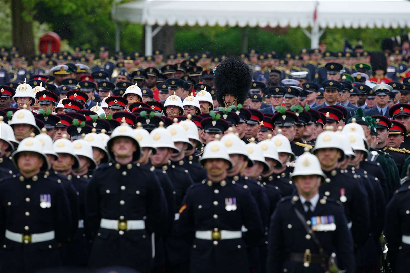 Members of the military prepare to give the royal salute to the King and Queen in the gardens of Buckingham Palace (Peter Byrne/PA)