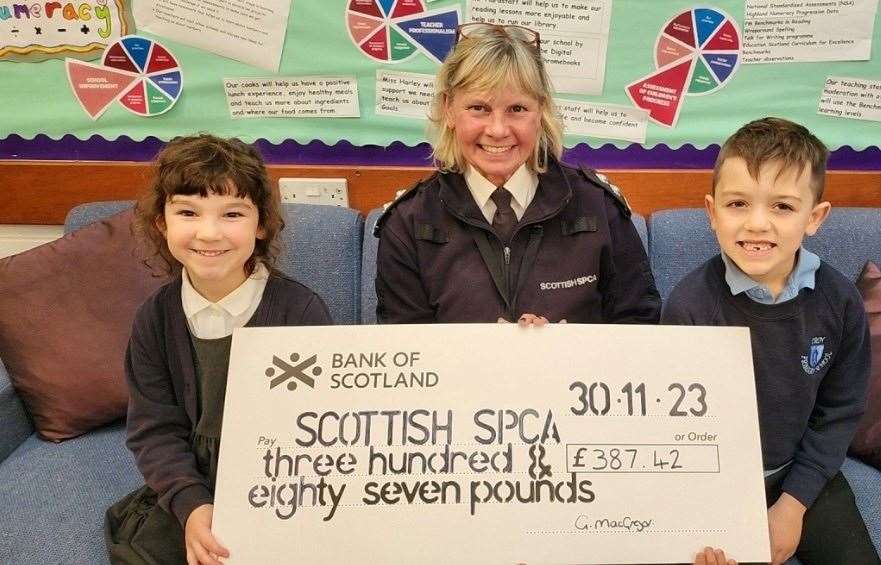Pupils Rowan Campbell and Owen Mackay presented the cheque to SSPCA senior inspector Gill MacGregor.