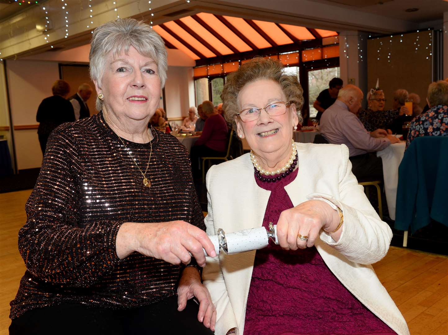 Secretary Mary Mackay and president June Alexander share a cracker. Picture: Gary Anthony.