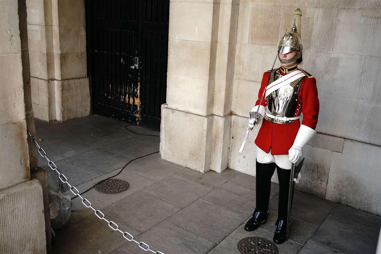 A member of the Household Troop had a fan placed next to him at Horse Guards Parade in central London (Aaron Chown/PA)
