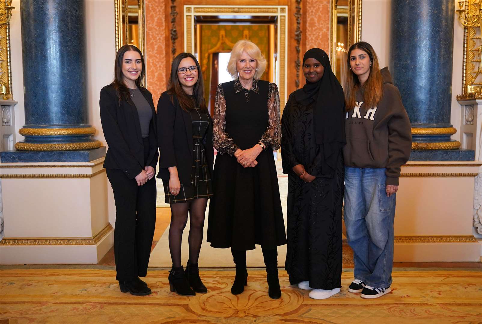 Queen Camilla (centre) with Changemakers Imi, Maya, Almas and Lybah (Yui Mok/PA)