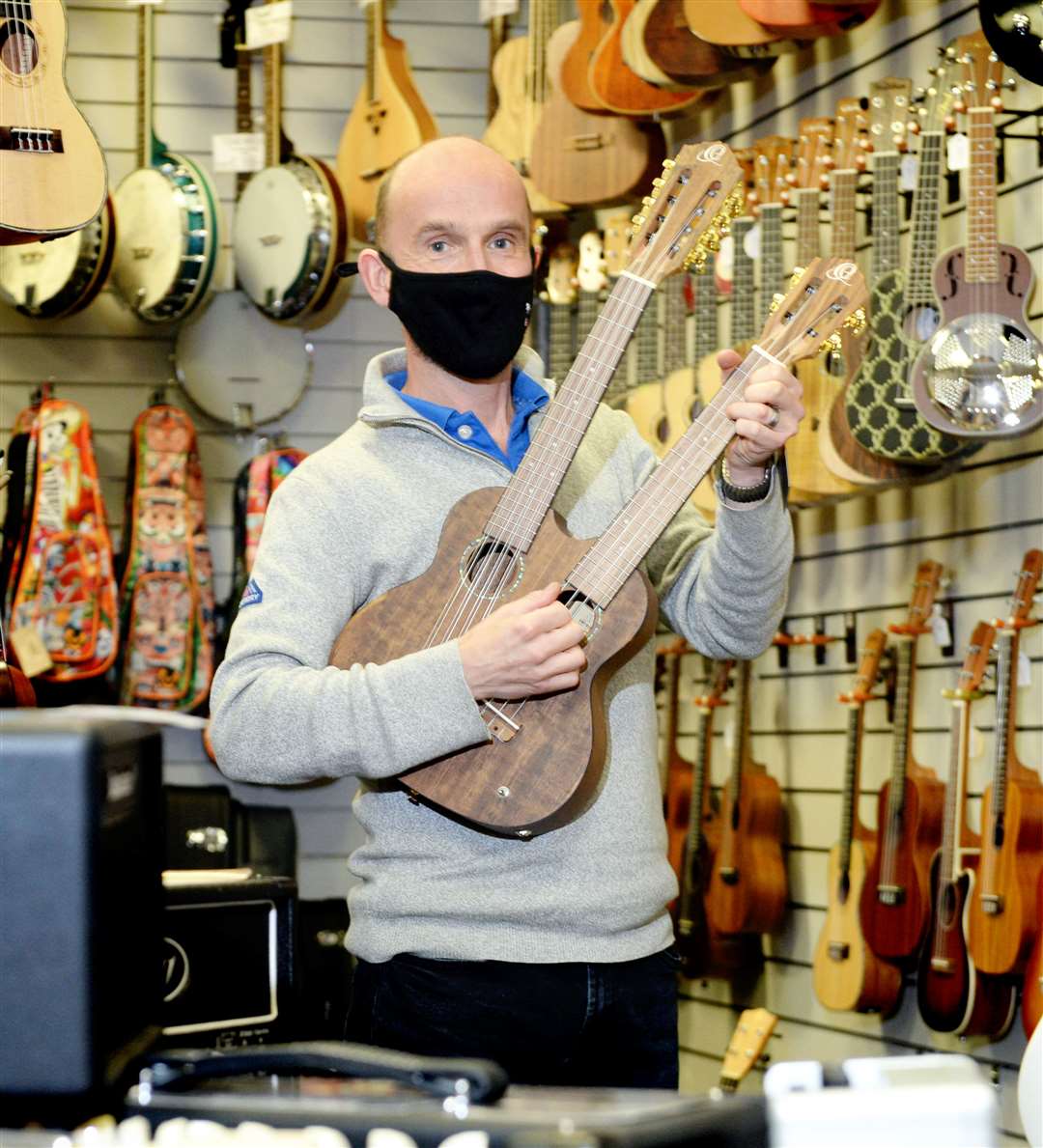 Roger Catherwood, owner of The Music Shop, with a twin necked ukulele.
