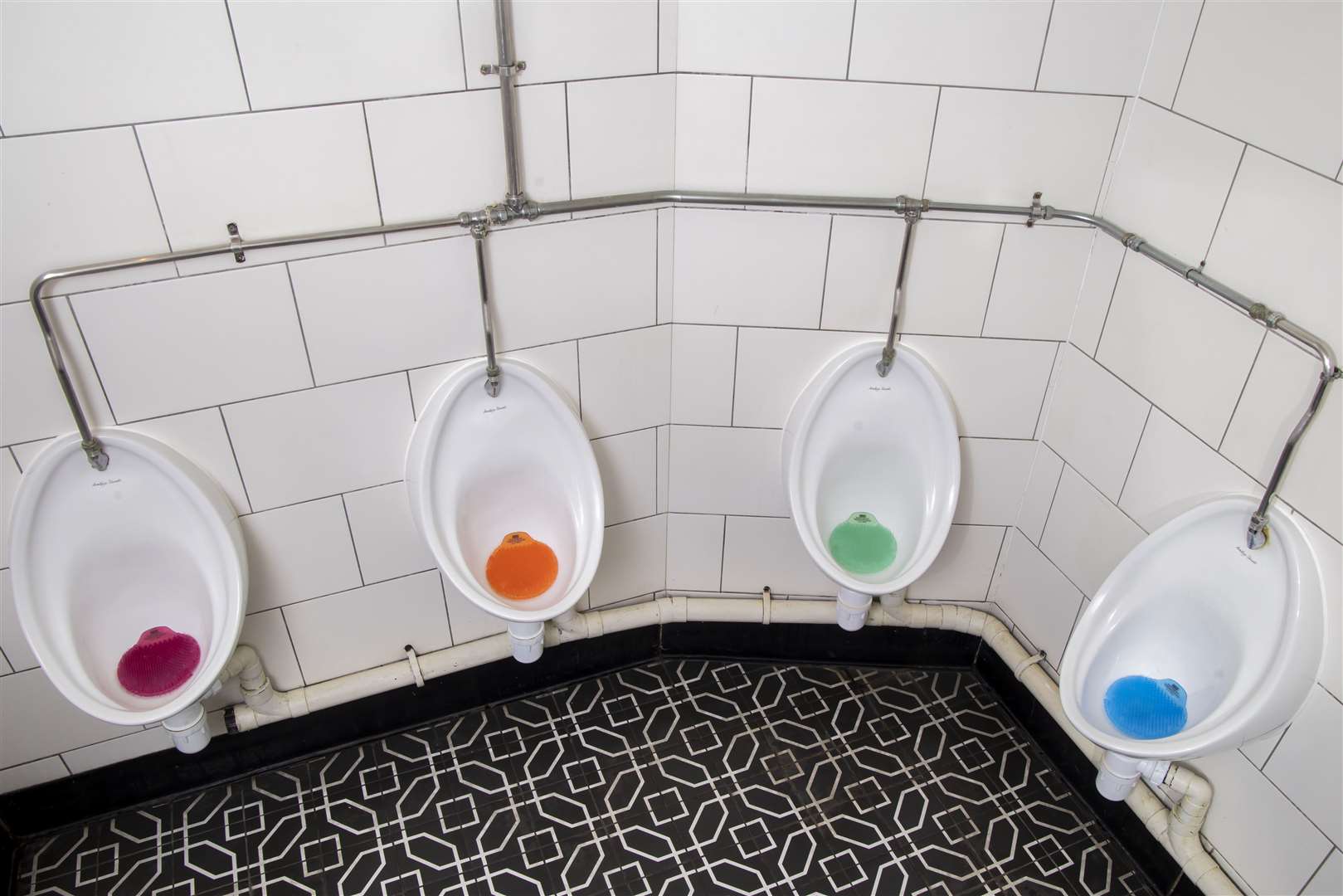 The mats sit inside urinals so men can read the message as they pee (NHS England/PA)