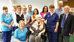 Mary Nicolson (front, kneeling); Beverley Manson (centre); Nicol Manson (far right); Lara McLeod (third from left) are joined by other members of the Manson family and staff from the Stroke Unit to mark the donation.