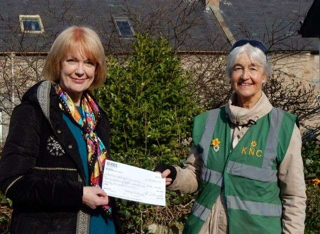 Morag Holding, chair of the now closed VisitNairn Tourism Association, handing over the funds to Annie Stewart of Keeping Nairnshire Colourful.
