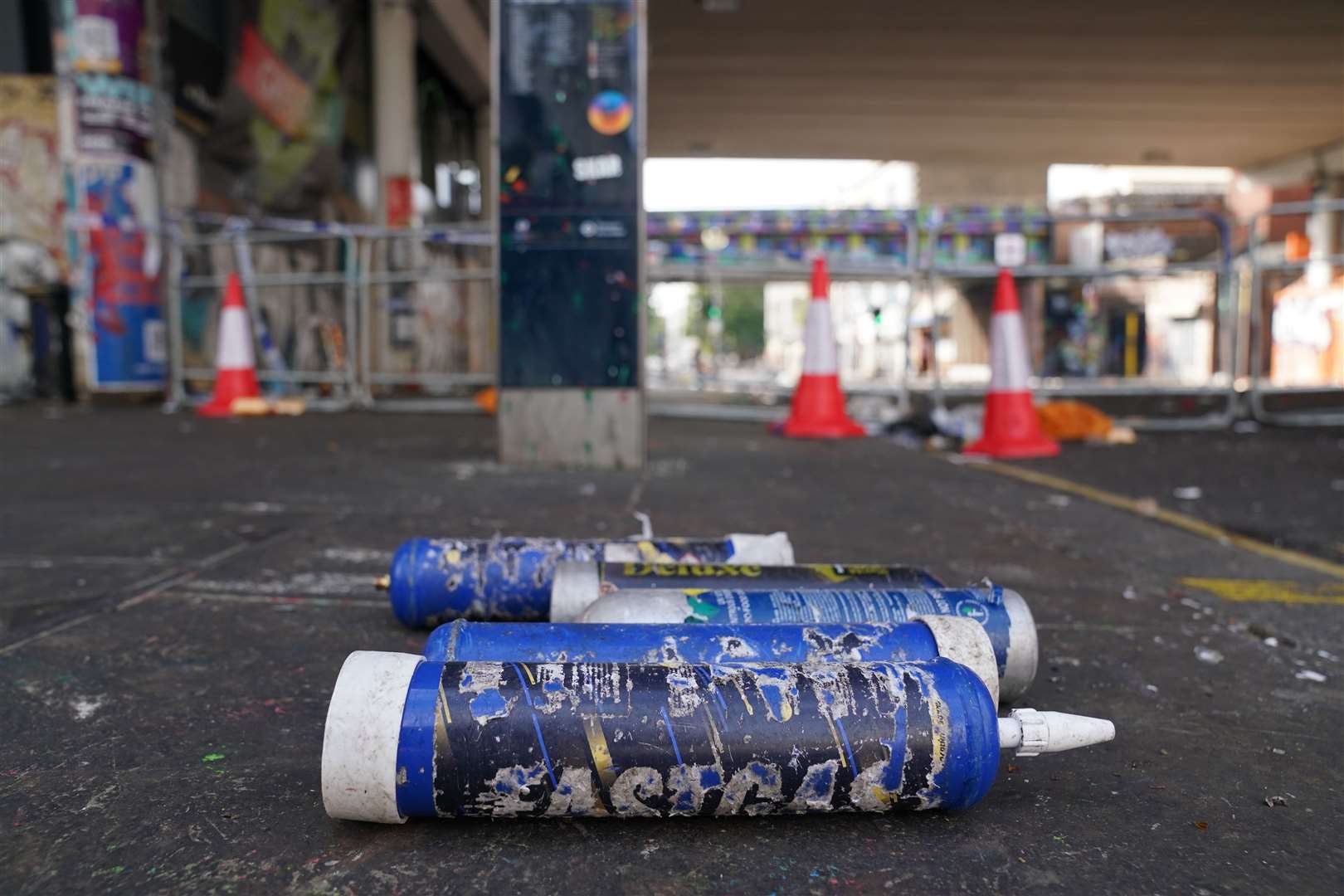 Nitrous Oxide gas canisters litter the street near to the scene in Ladbroke Grove, west London (Kirsty O’Connor/PA)