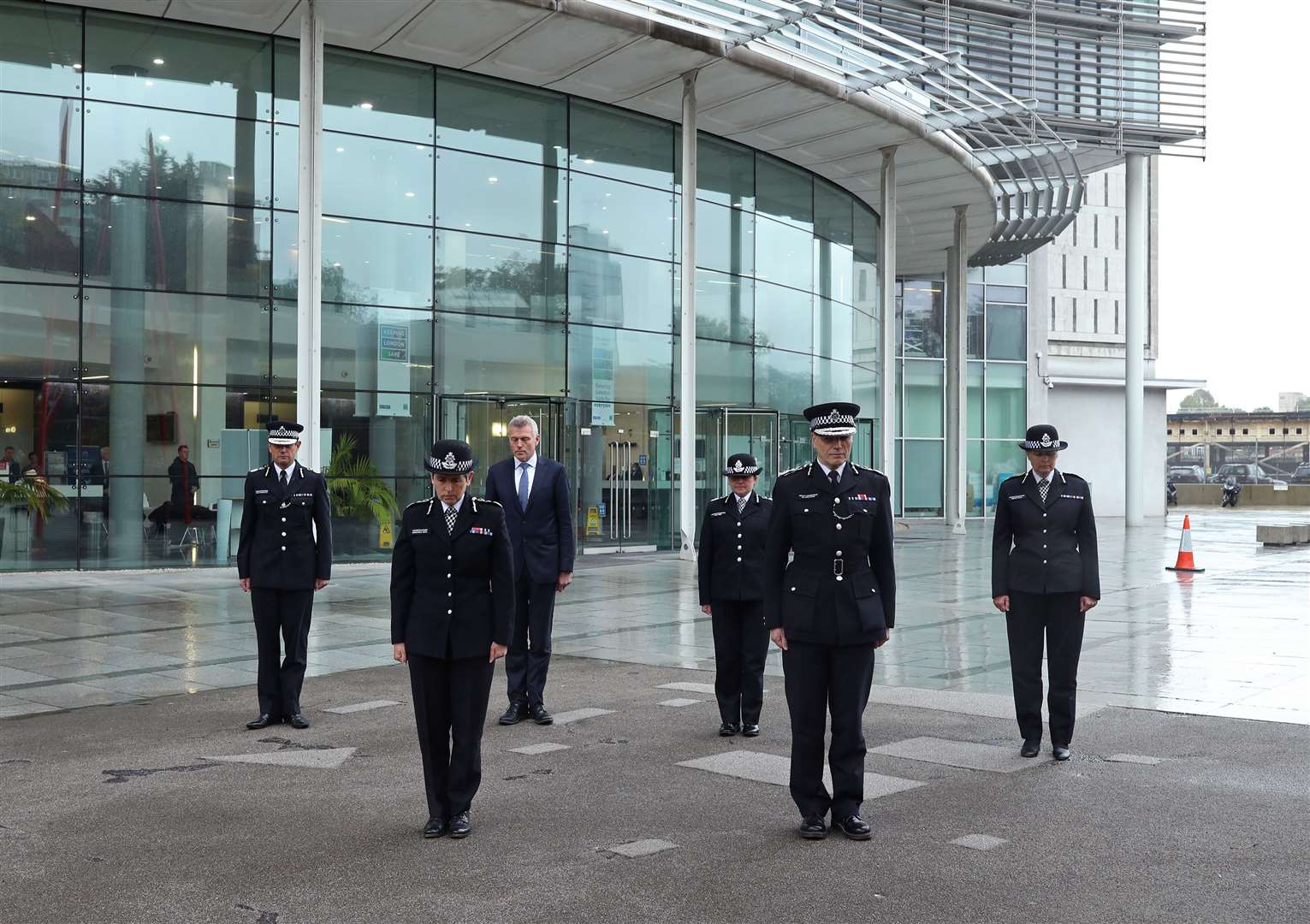 Metropolitan Police Commissioner Dame Cressida Dick (2nd left) and colleagues observe a minute’s silence for police officer Sergeant Matt Ratana at the Empress State Building, London (Yui Mok/PA)