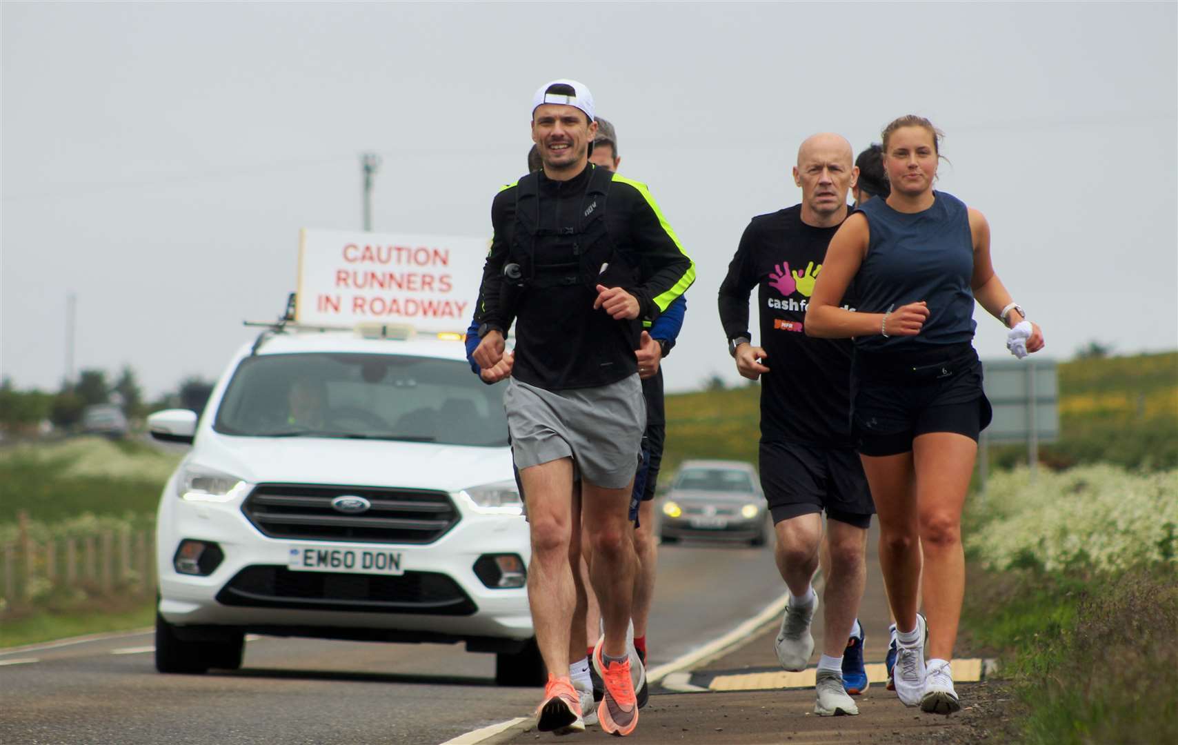 Steven Mackay and fellow runners heading south from Wick on the first stage of the journey in aid of MFR Cash for Kids. Picture: Alan Hendry
