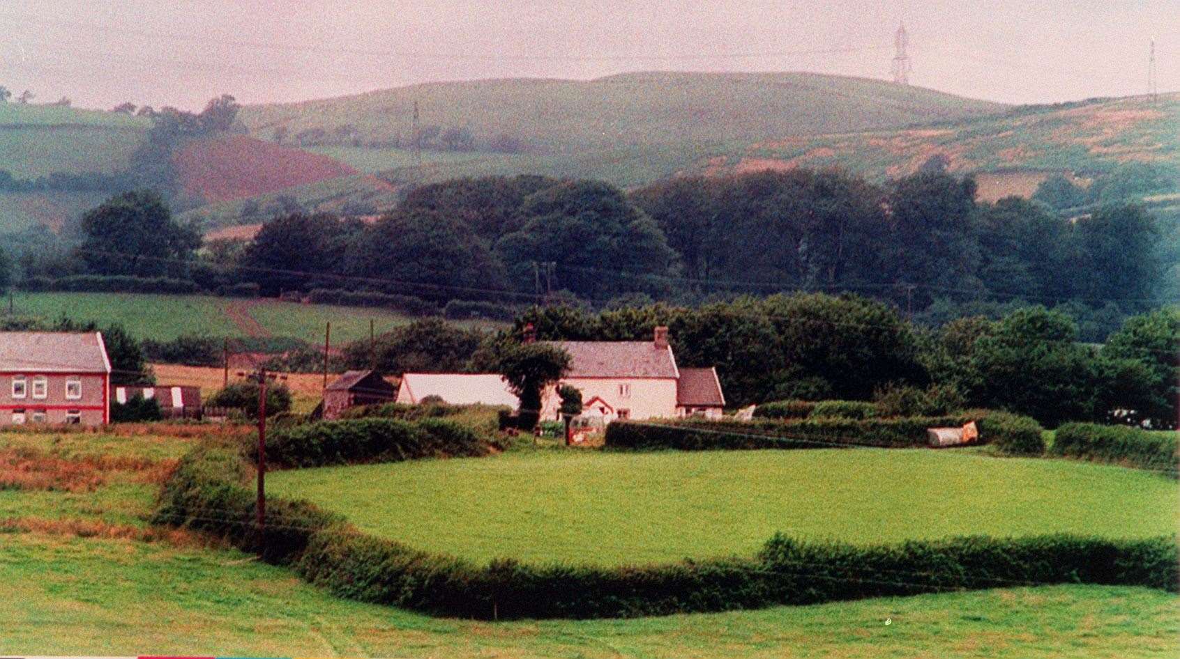 The isolated farmhouse at Llanharry where the bodies of Harry and Megan Tooze were discovered in 1993 (PA)